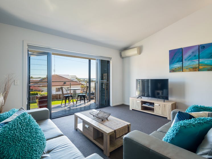 Lounge opening up onto north facing balcony with water views