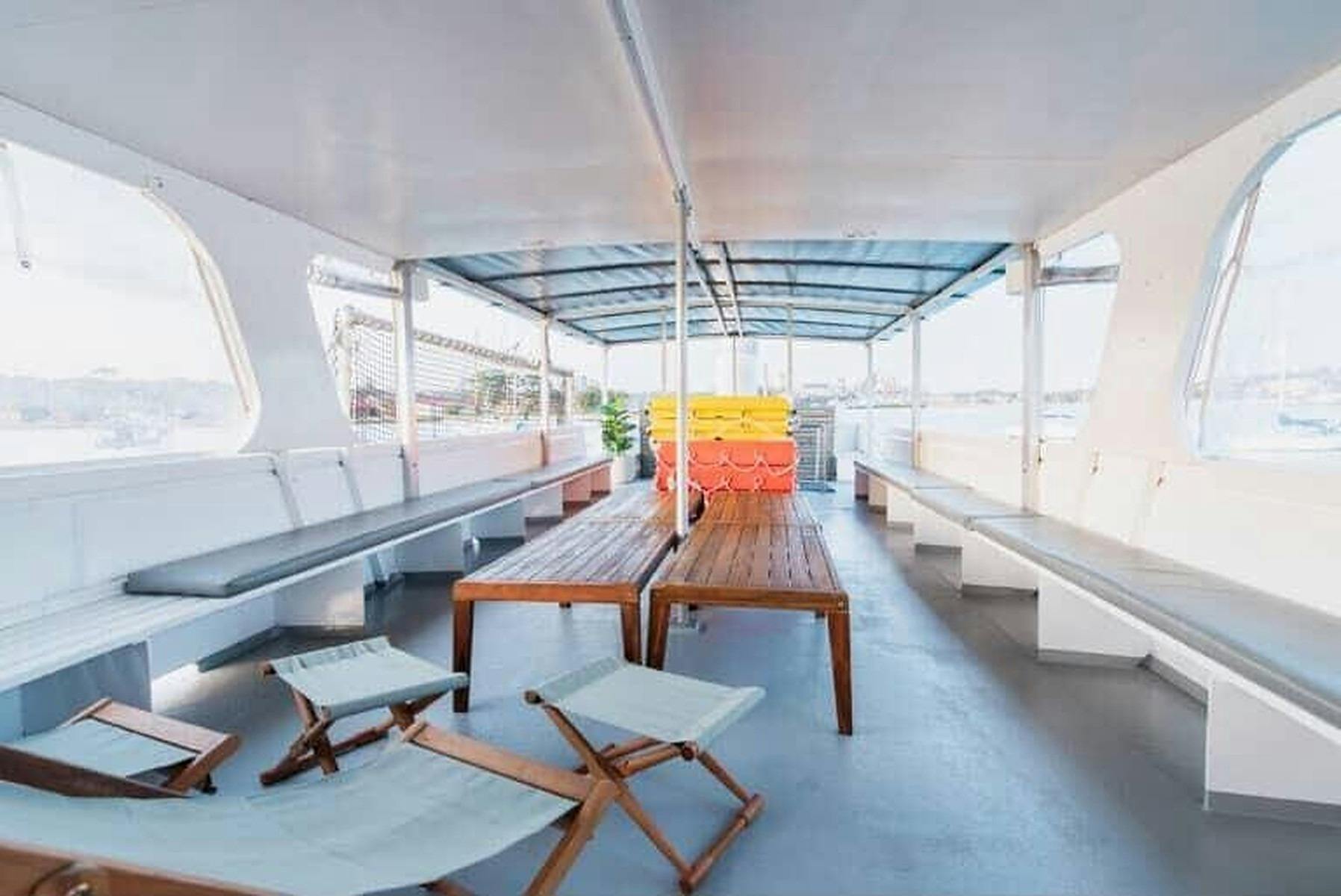 Interior of Zahara with green lounge seating along both sides, timber floors and a bar at the far en