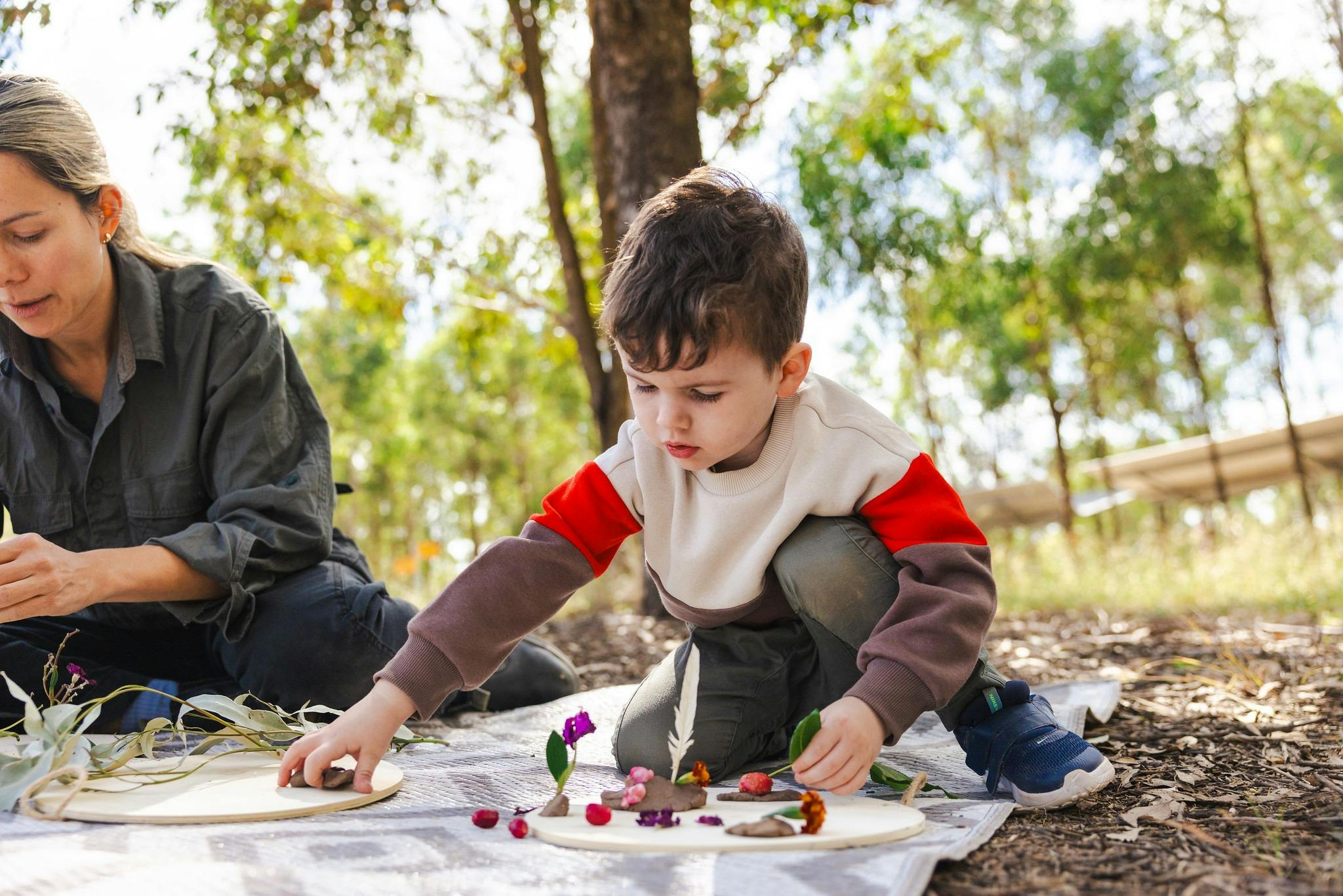 Toddler playing with natural materials outdoors