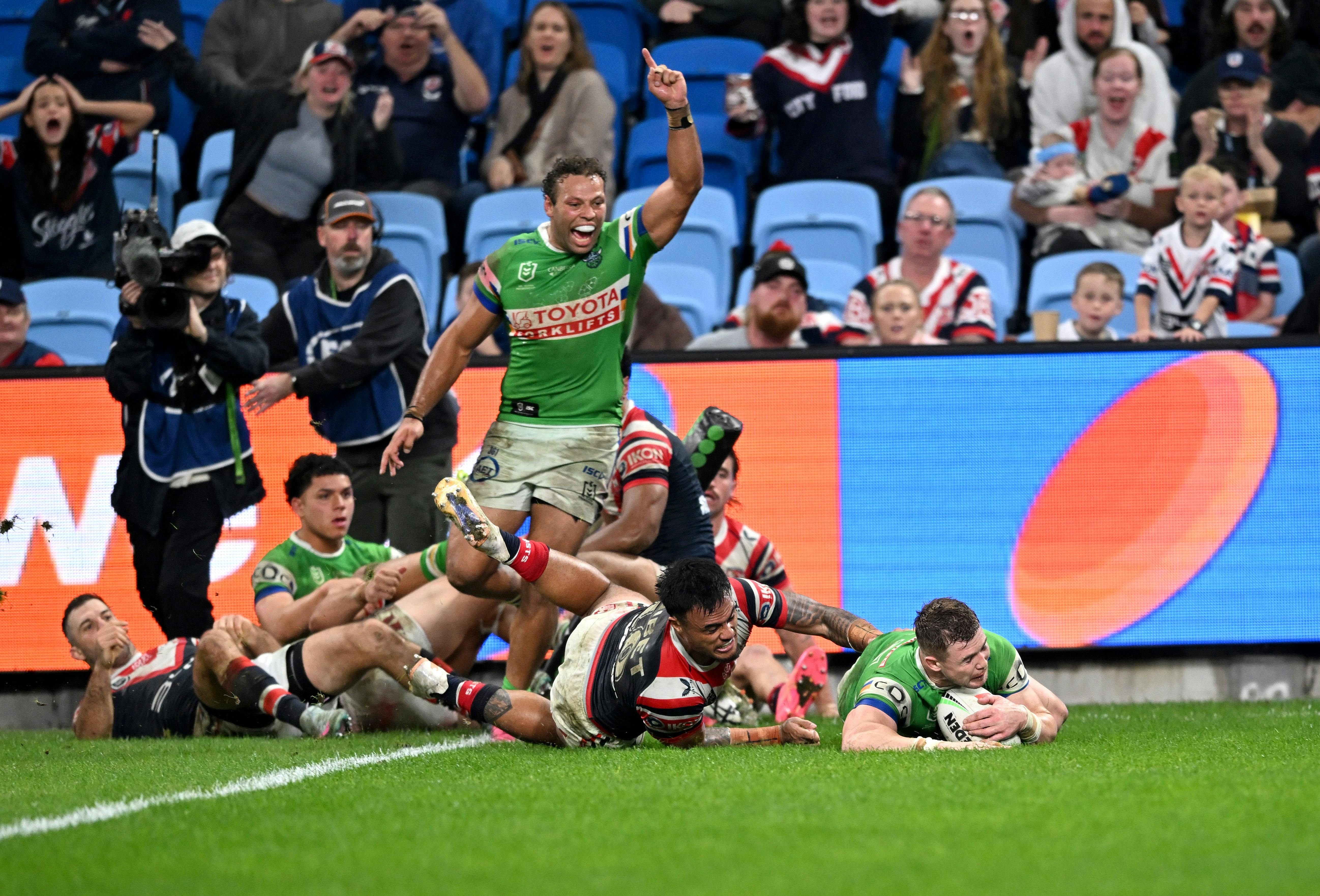 Canberra Raiders player Hudson Young scoring a try as Sebastian Kris celebrates.