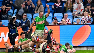 Canberra Raiders player Hudson Young scoring a try as Sebastian Kris celebrates.