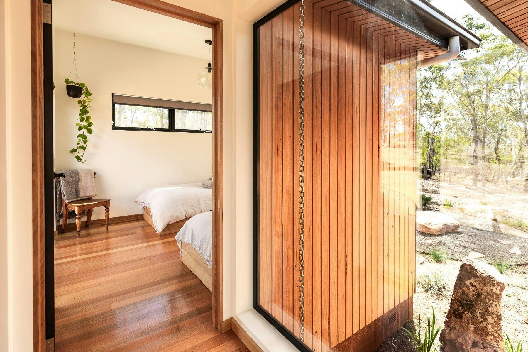 A large glass entry foyer with twin beds in second bedroom