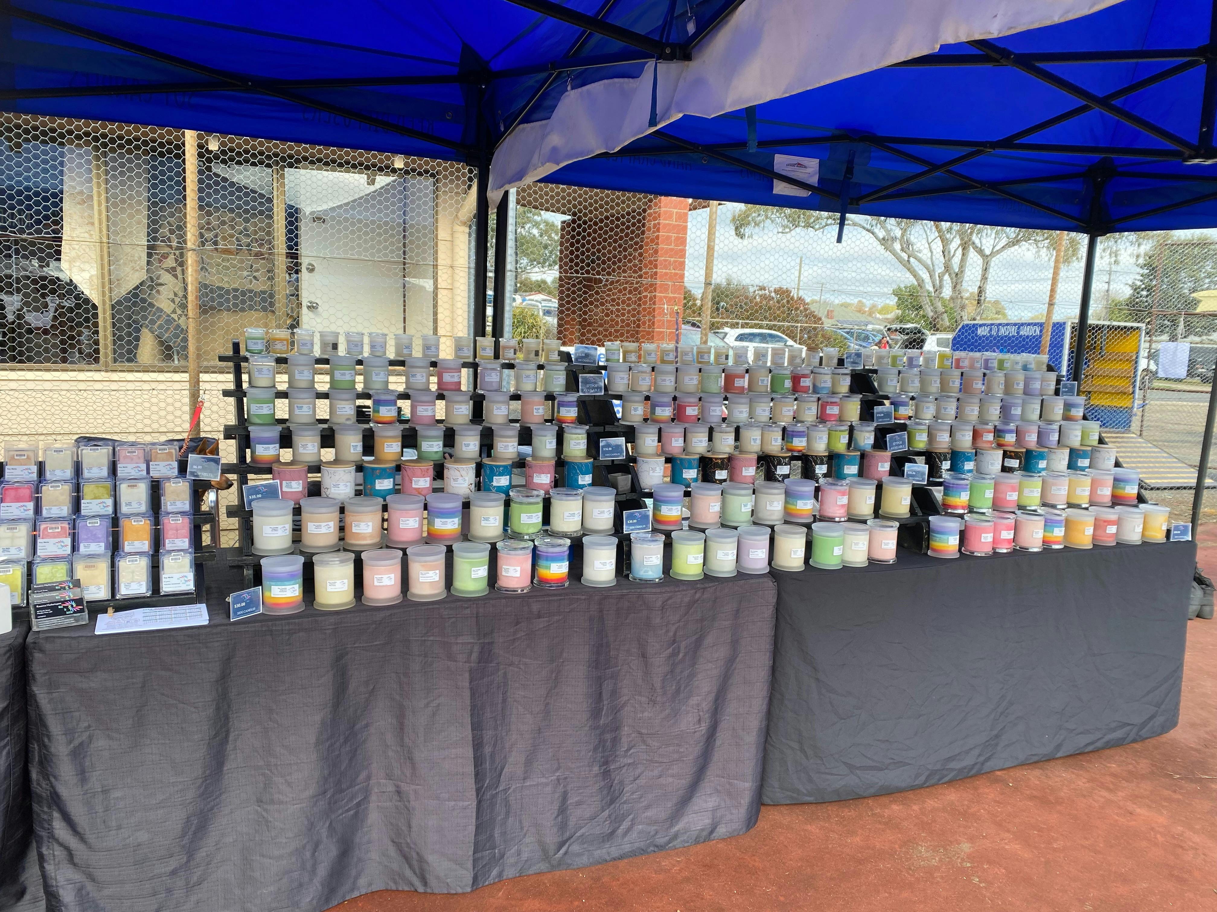 Market stall with a variety of scented candles.