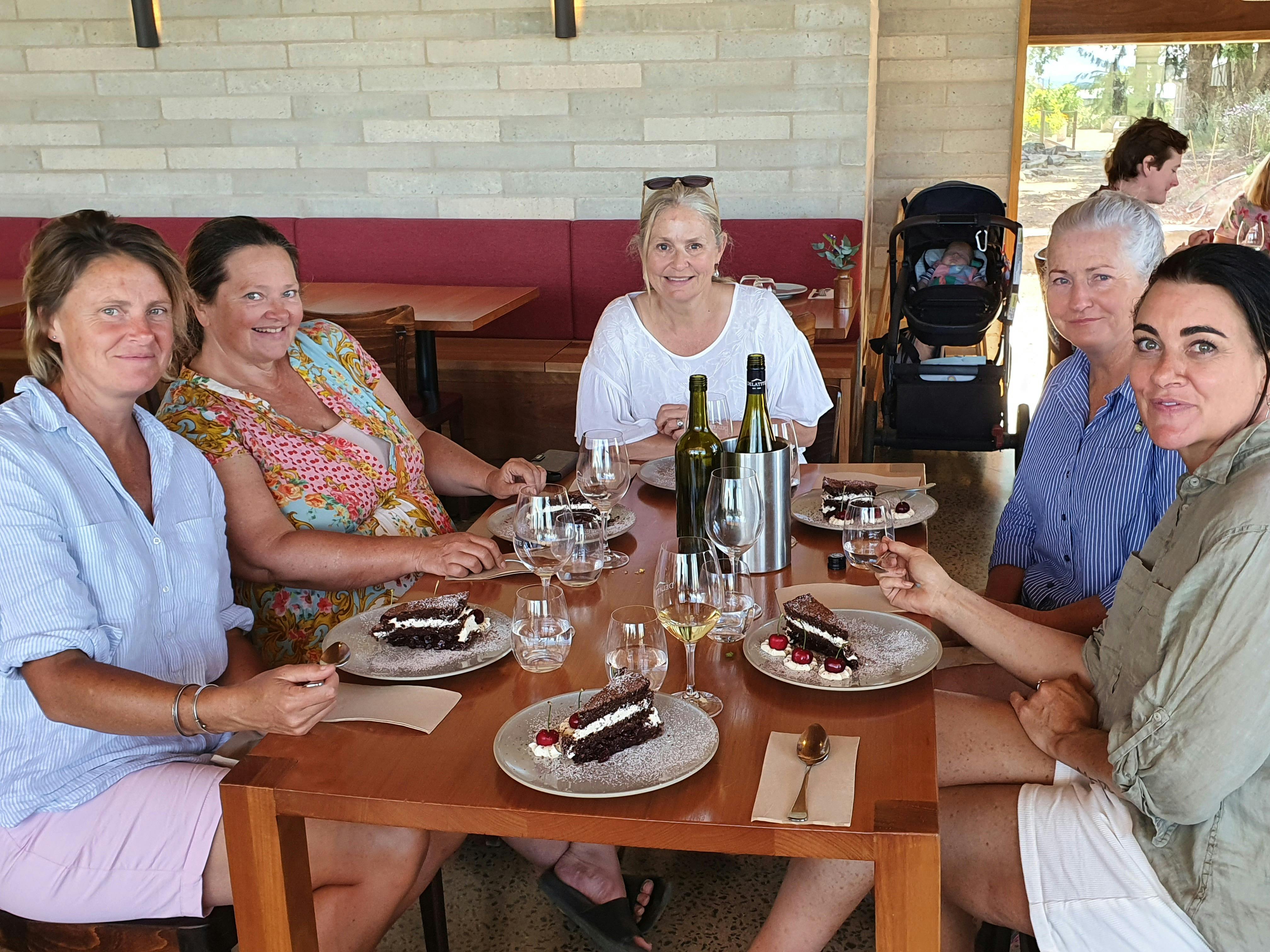 artists sitting around a table in the Delatite winery having lunch