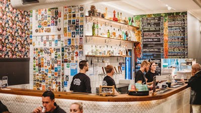 Group of people working behind a bar