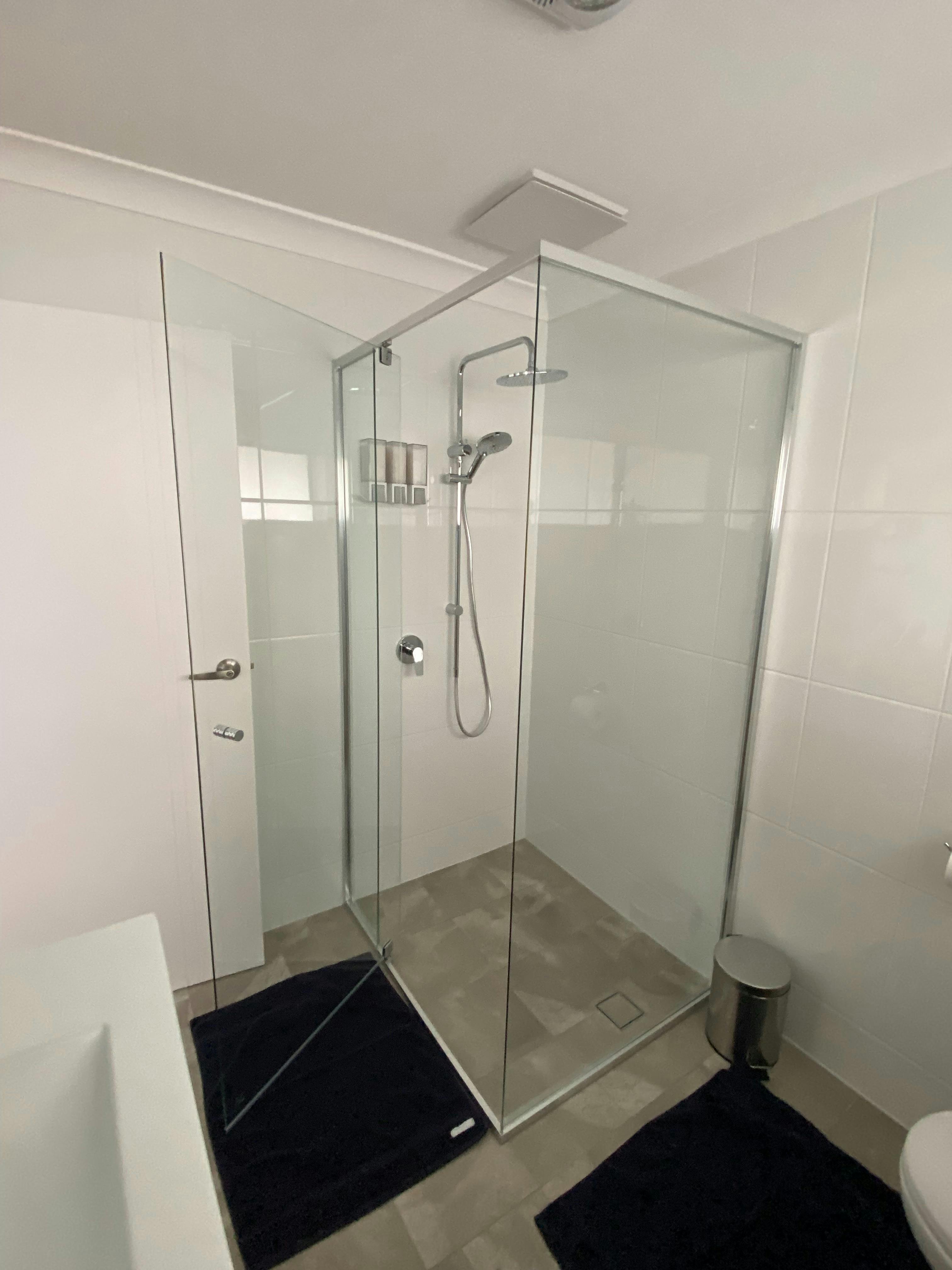 Modern large double shower heads, body wash, shampoo and conditioner