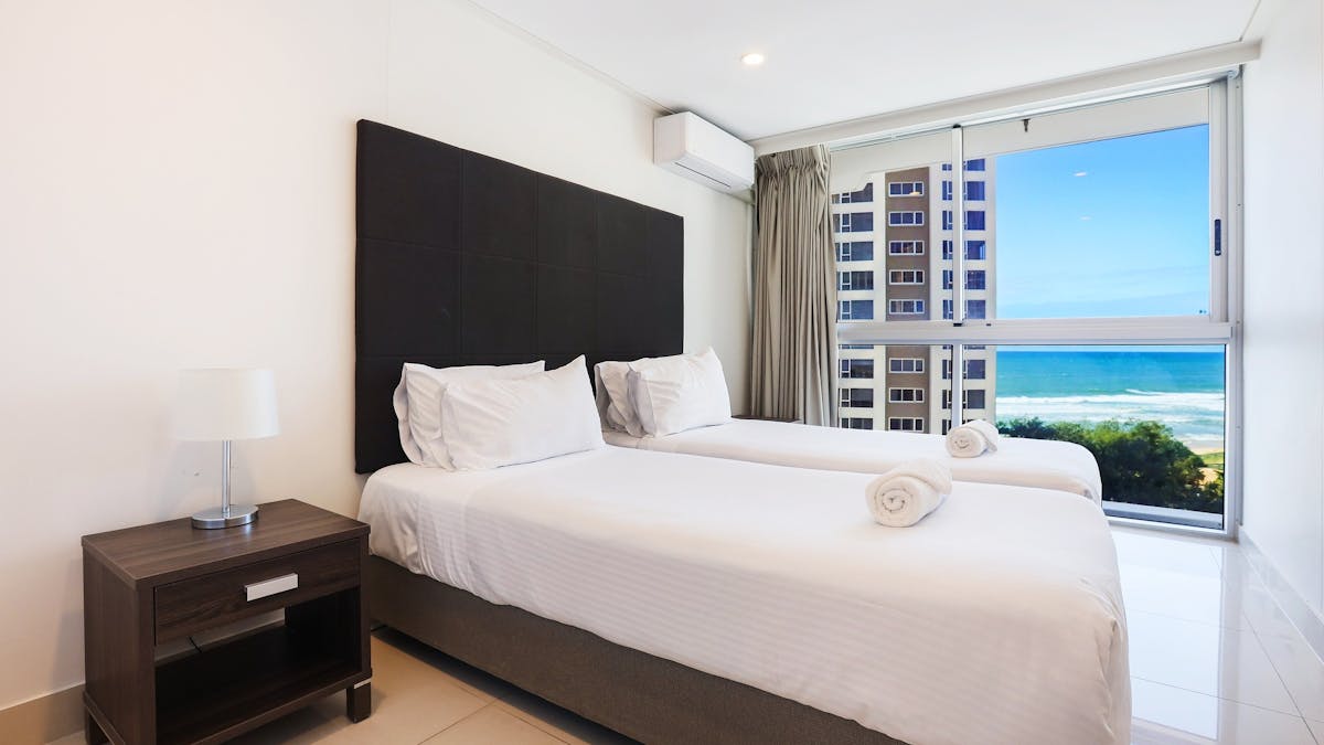 Second bedroom with 2 single beds, ocean views, tile floors - Gold Coast Holidays Surfers Paradise
