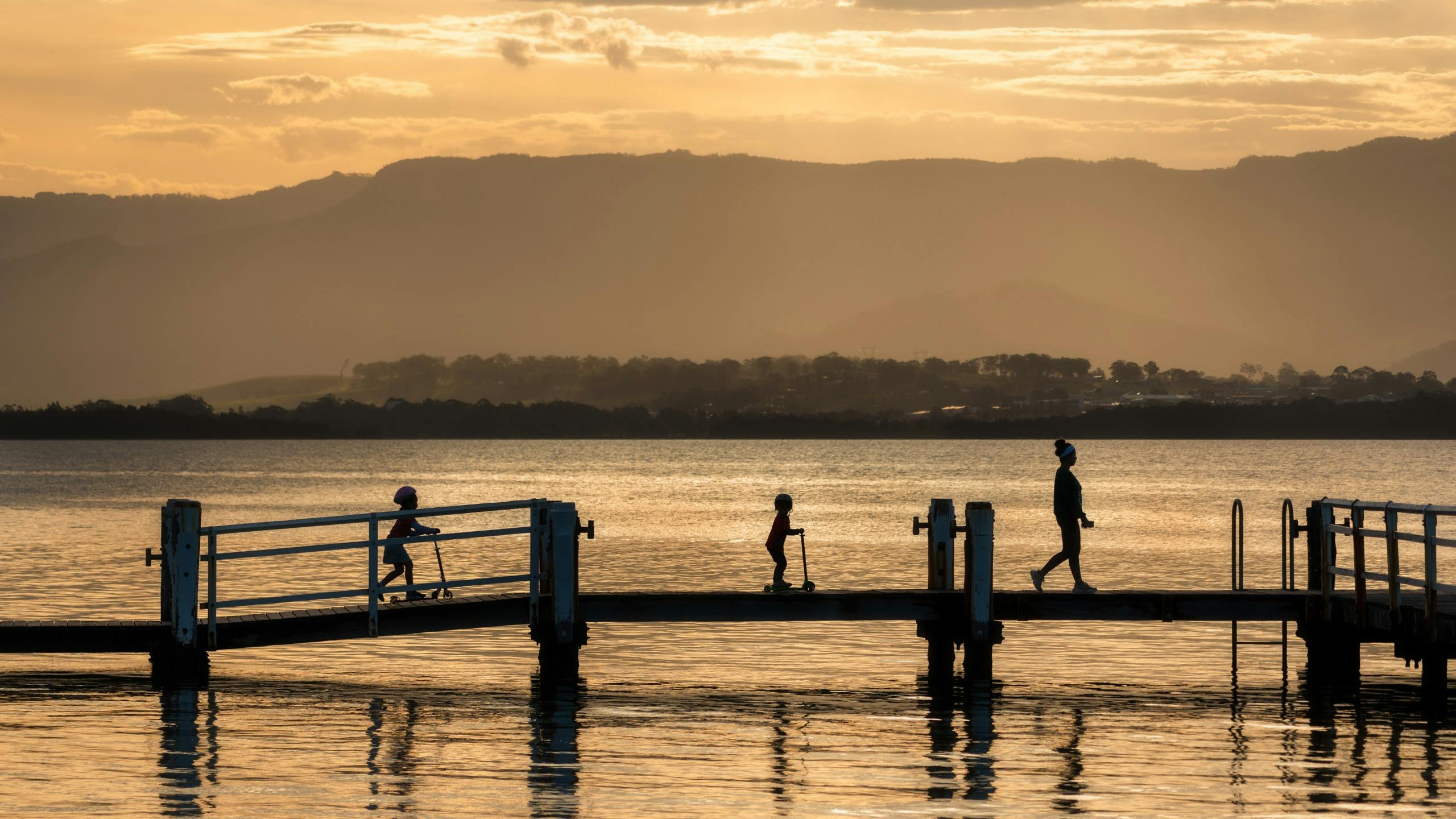 Family waking on the jetty at Lake Illawarra