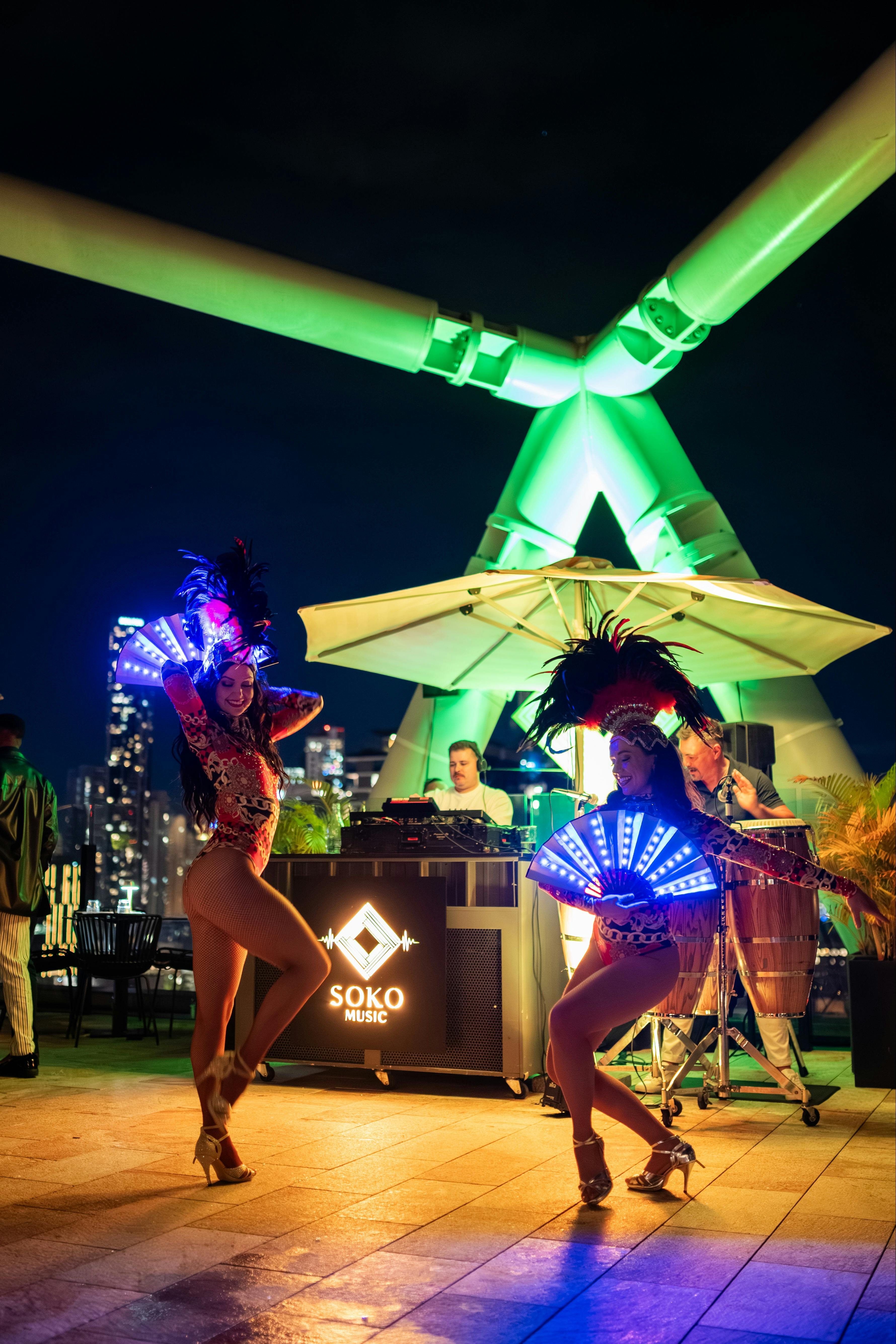 Two women dancing samba on the rooftop of Soko