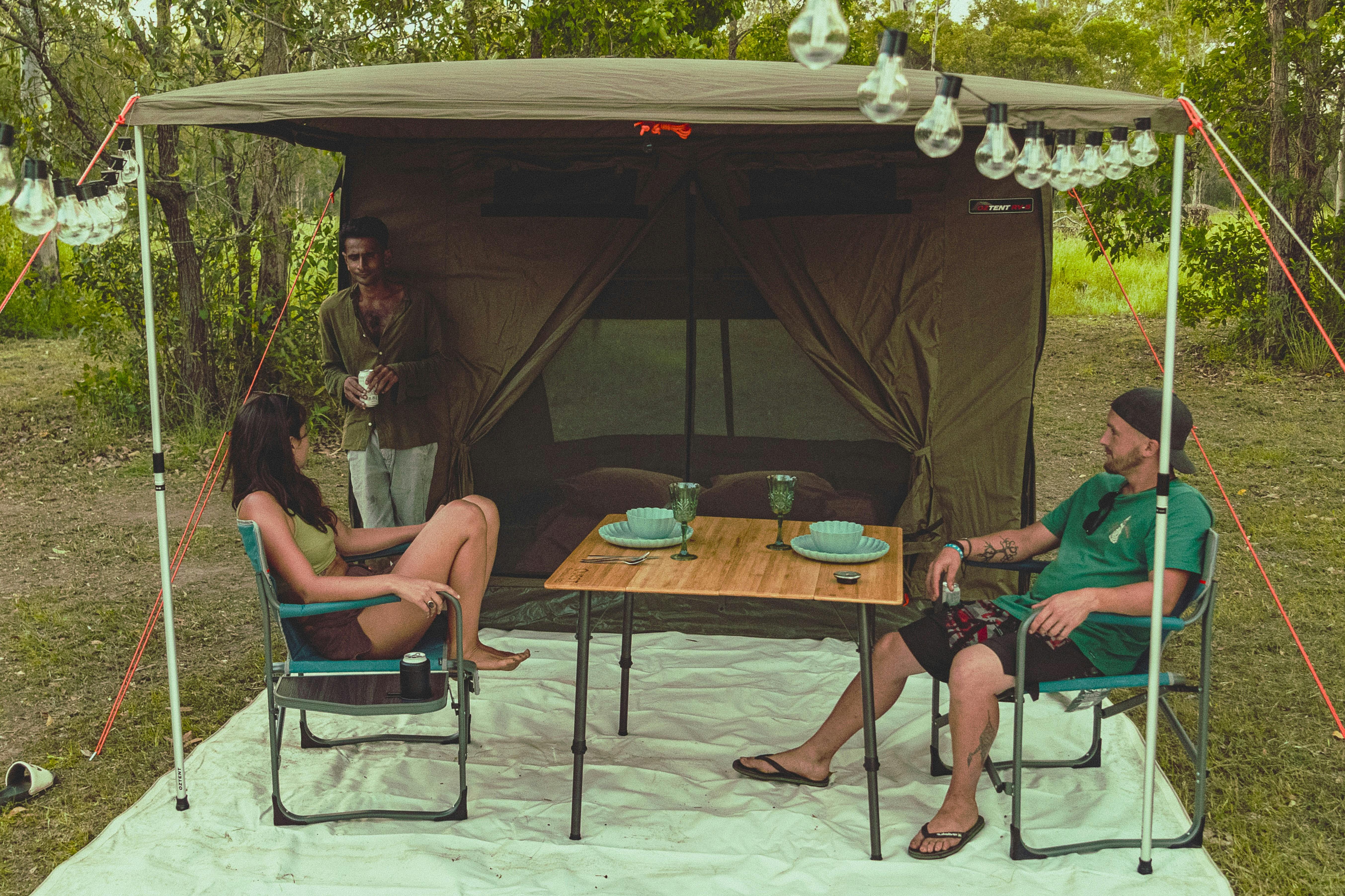 two people relaxing infront of a glamping safari tent