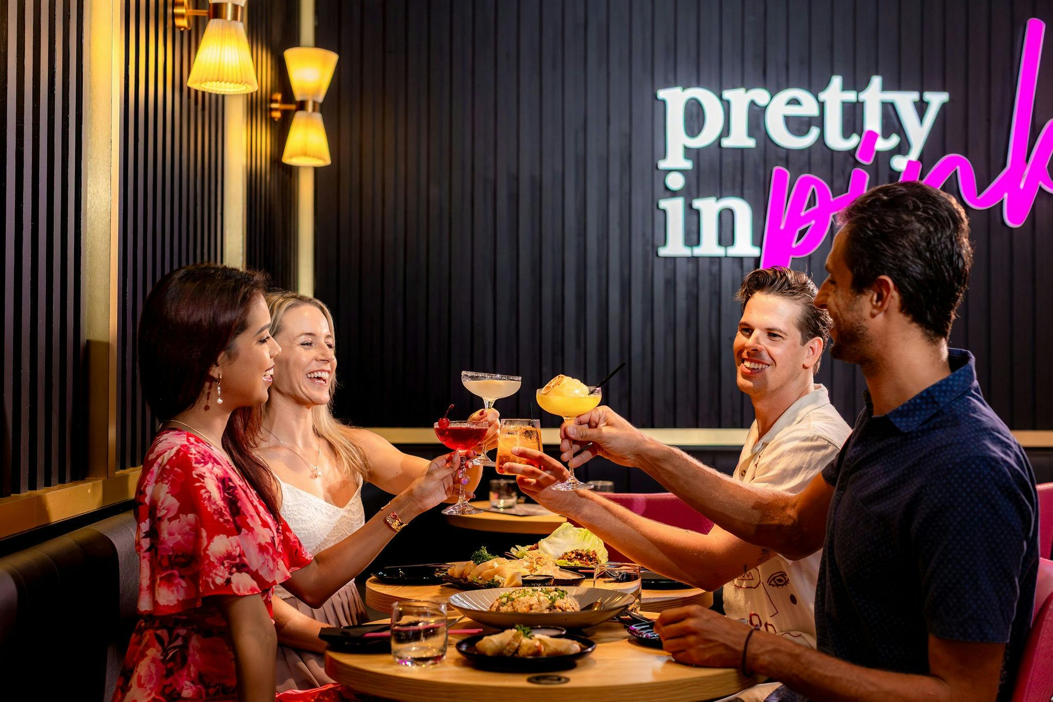 toasting cocktails over a large seafood spread at Pink Chopstix