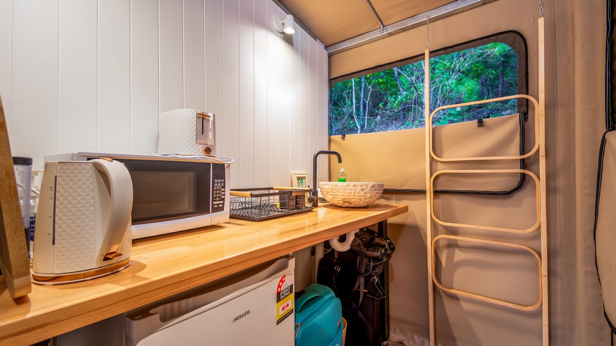 Kitchenette has microwave toaster refrigerator basin