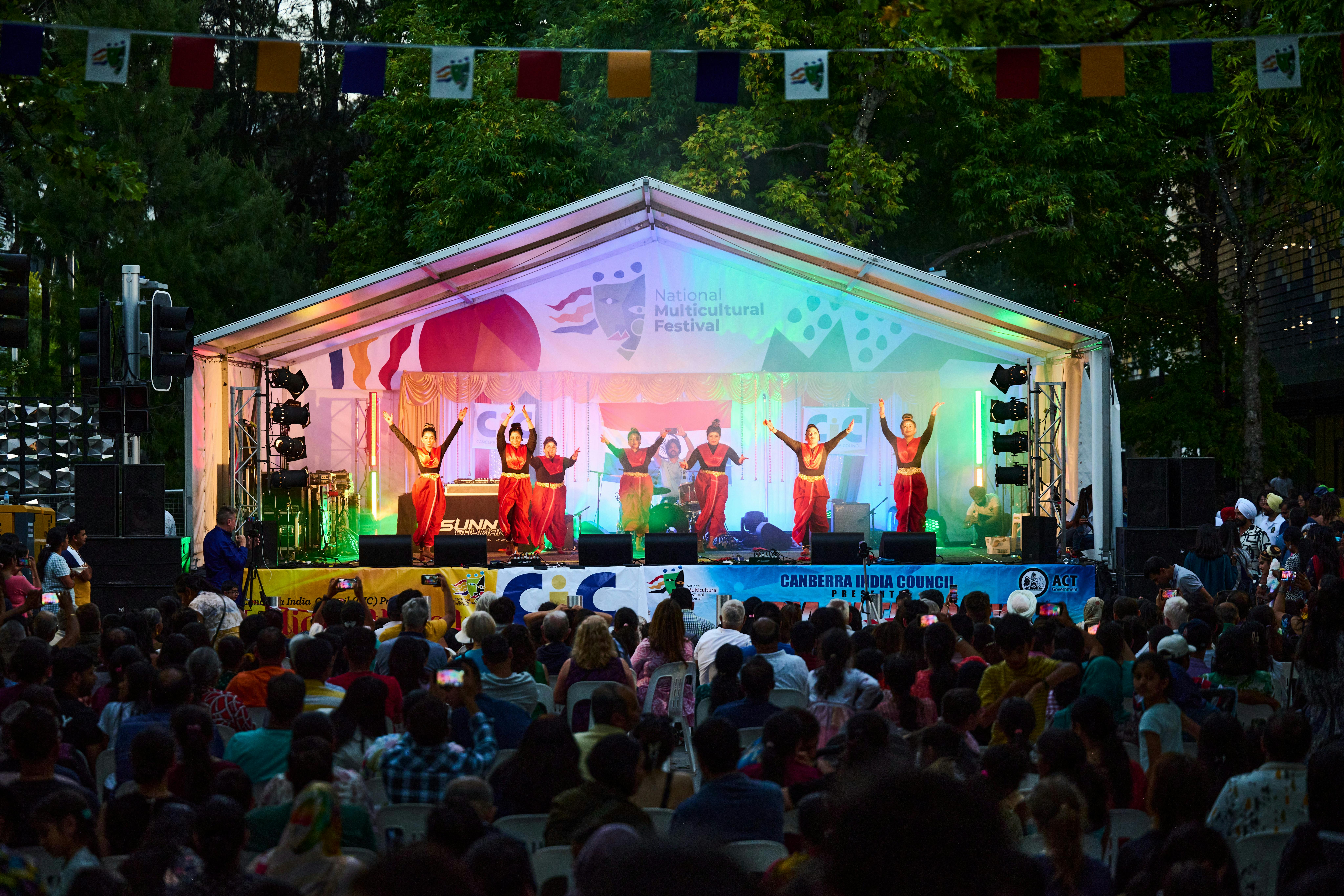 A group of women dancing on stage at the festival