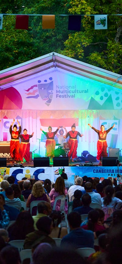 A group of women dancing on stage at the festival