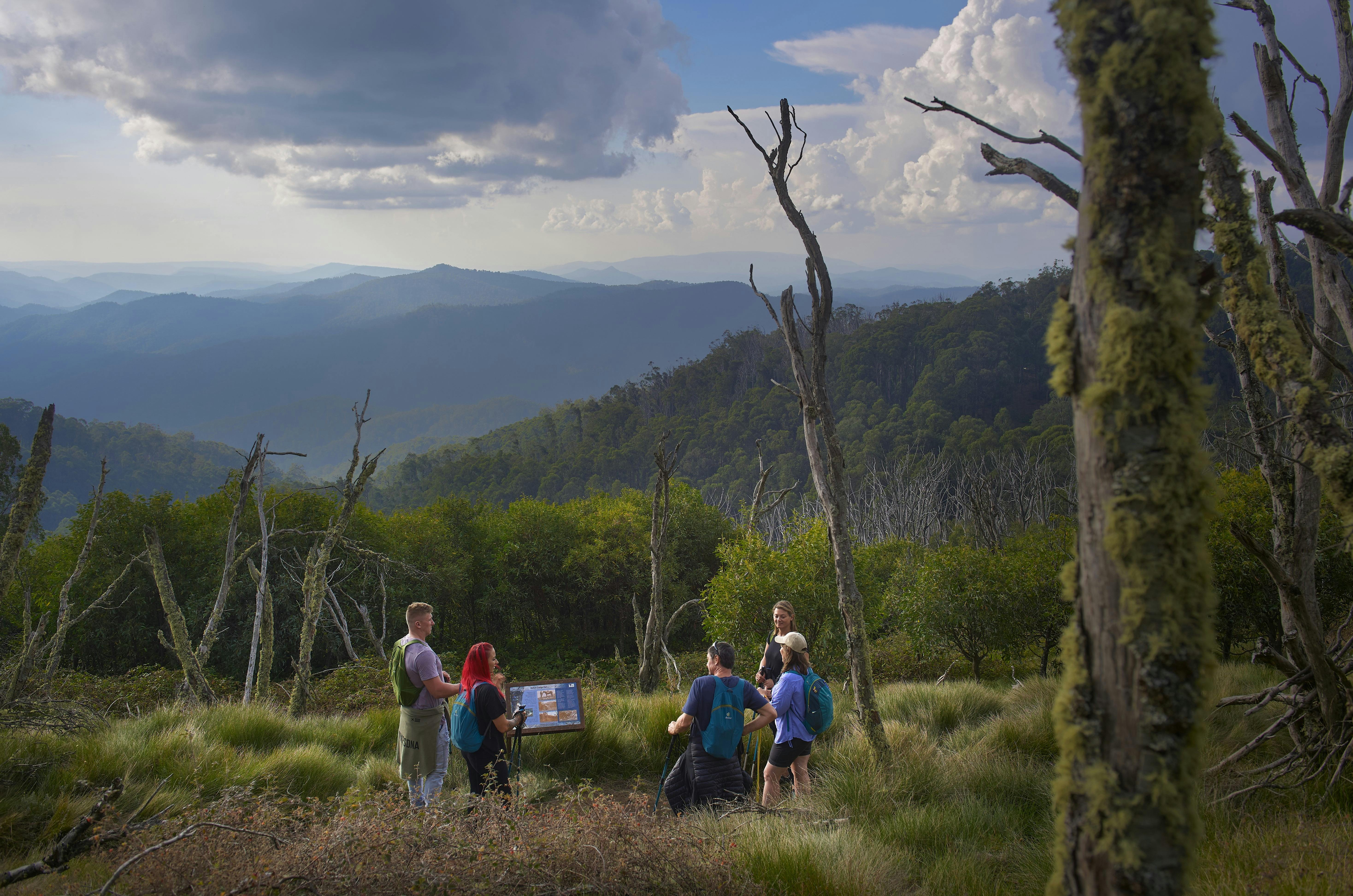 A group of hikers stopping to enjoy views across the mountains.