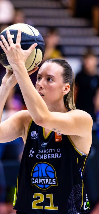 UC Capitals player shooting the basketball.