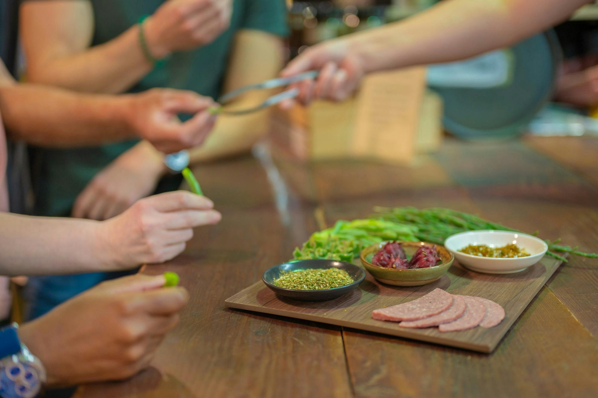 People reach for native food on a platter.