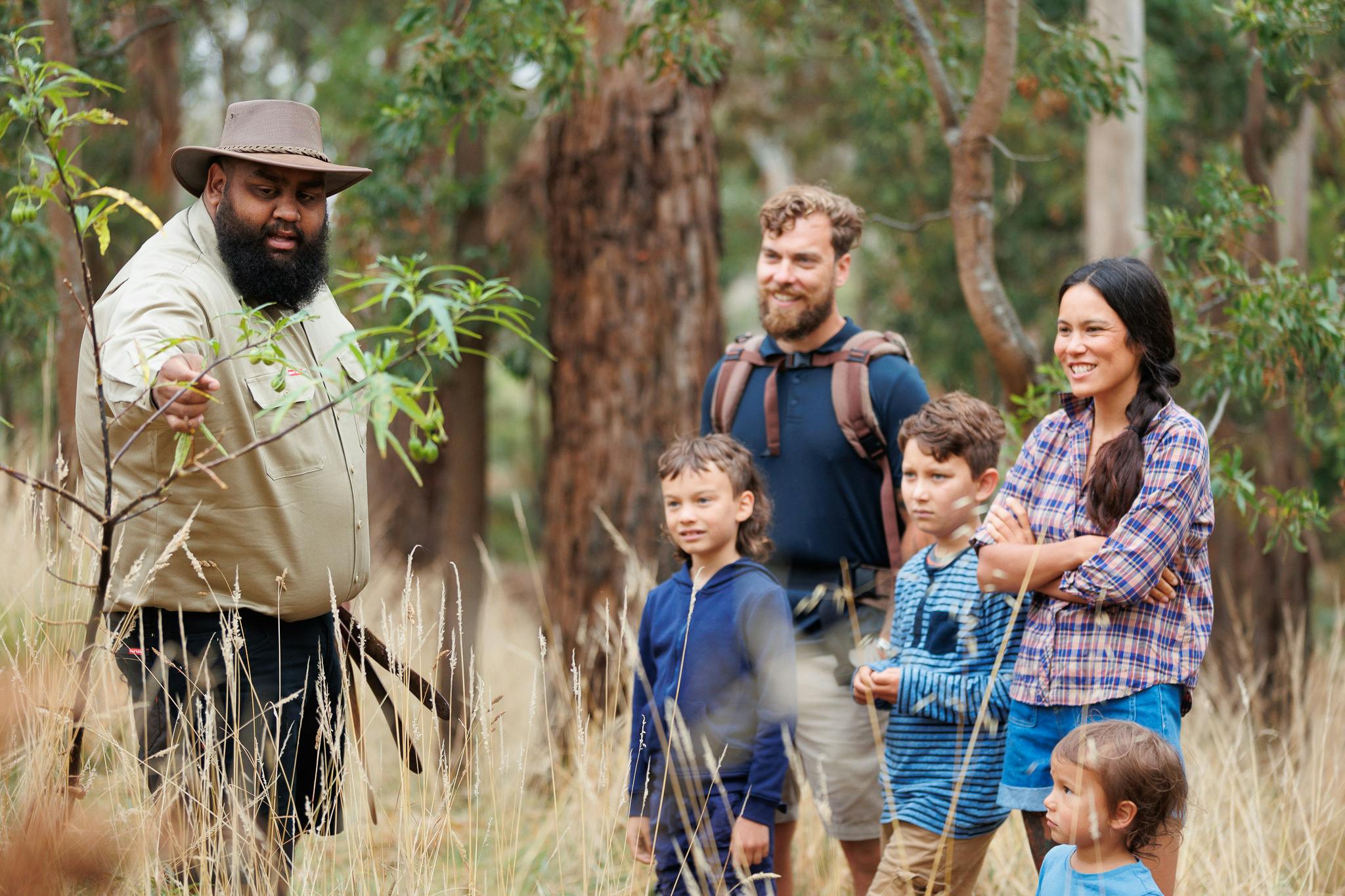 Aboriginal guide with visitors in the bush
