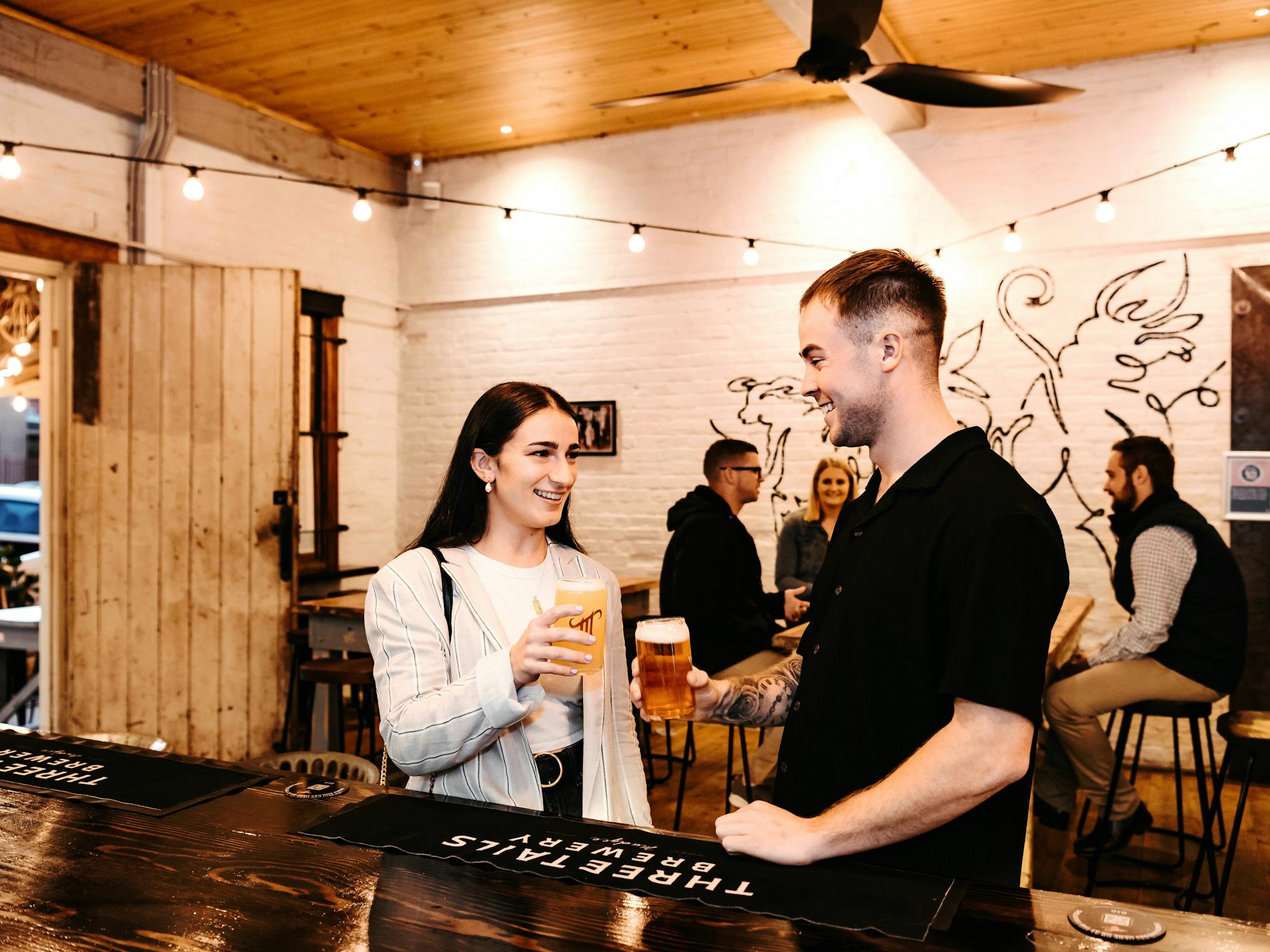 A man and woman chatting while enjoying a drink