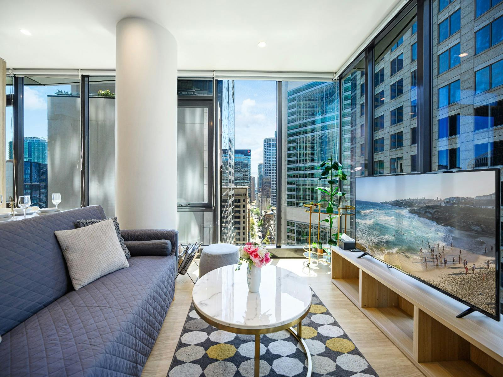 Alternate living area angle showing sofa (sofa bed) and balcony access.