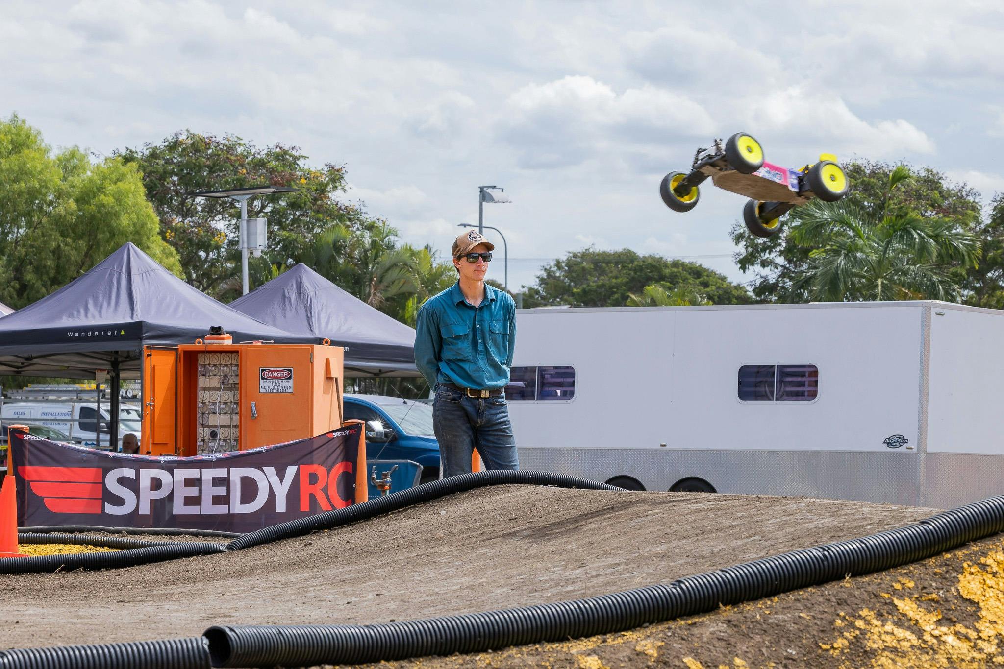 Remote control car jumping over a dirt track during Rockynats.
