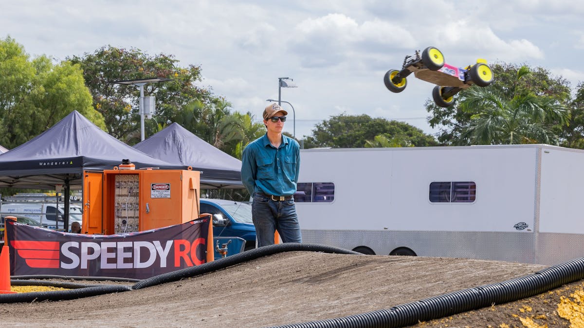 Remote control car jumping over a dirt track during Rockynats.