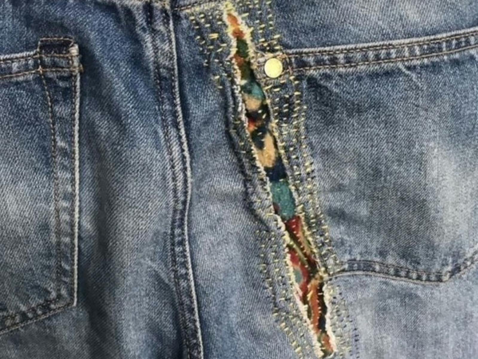 Jeans with a rip that has been repaired