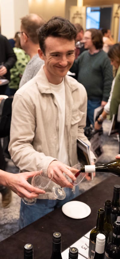 Young men having wine poured into their glass