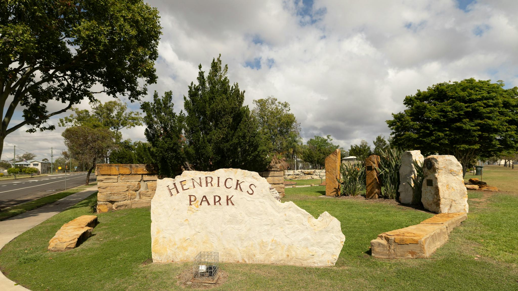 A large sandstone sign inscribed with 'Henricks Park' A large sandstone sign inscribed with 'Henricks Park'
