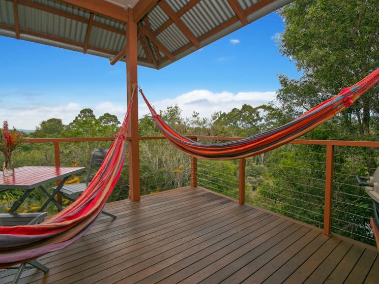 Secluded deck with hammocks and Weber BBQ for nature retreat; unwind amidst native birdsong.
