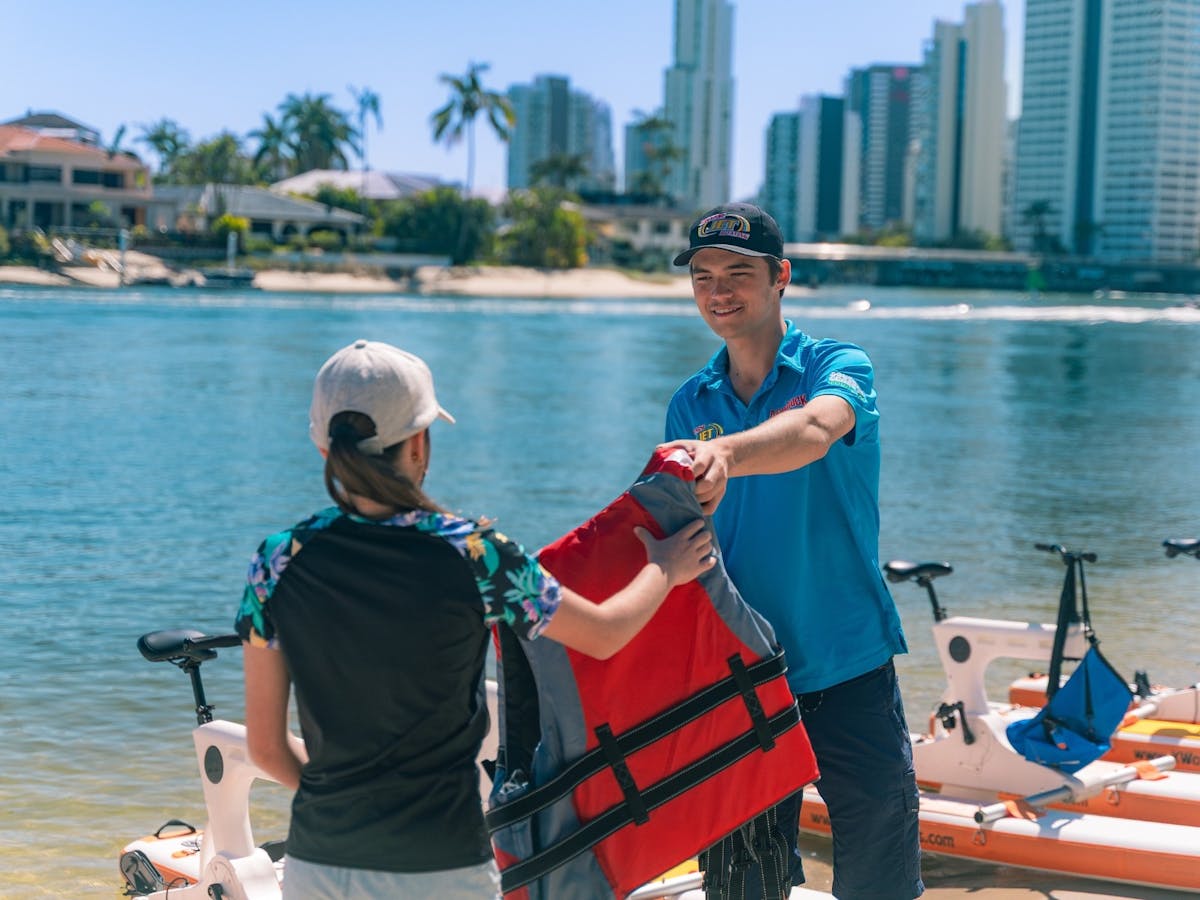 Paradise Waterbikes Crew member handing out life jackets