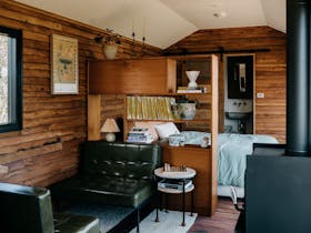 A daylight photo of the carriage interior showing the lounge and bedroom area