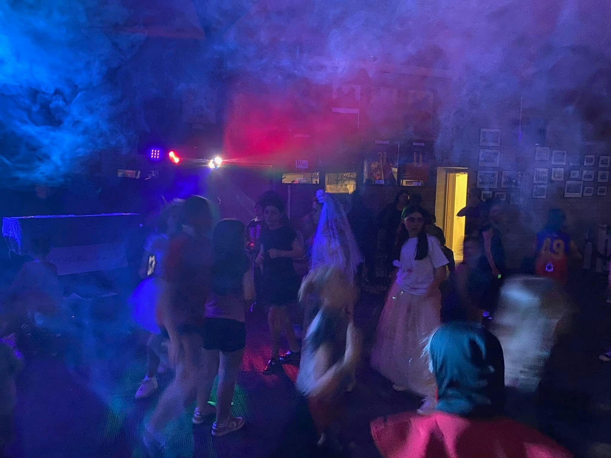 Disco dance floor with laser lights, smoke machine and kids dancing