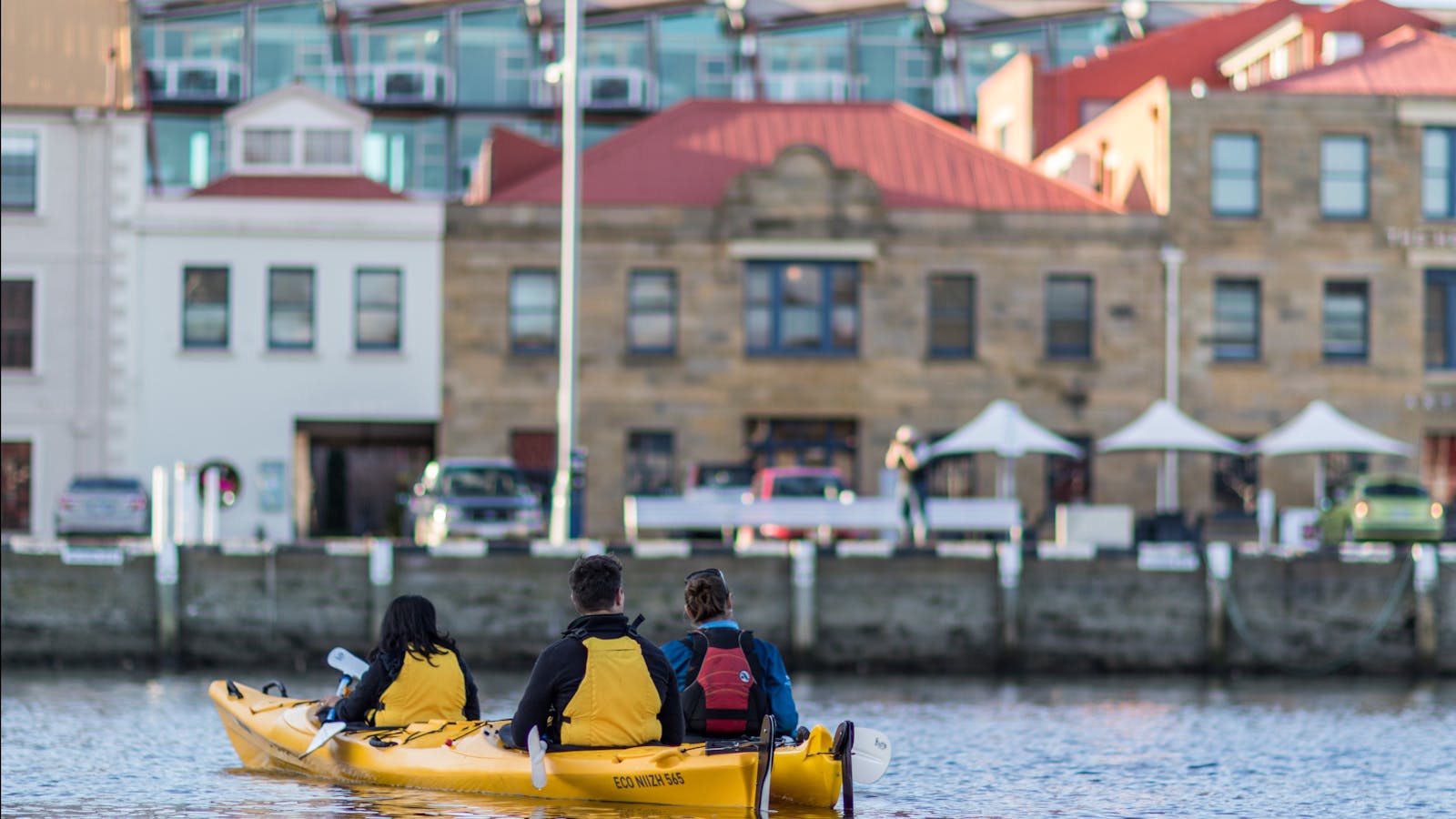 Kayakers relaxing on the water enjoying the view of heritage buildings on the Hobart waterfront