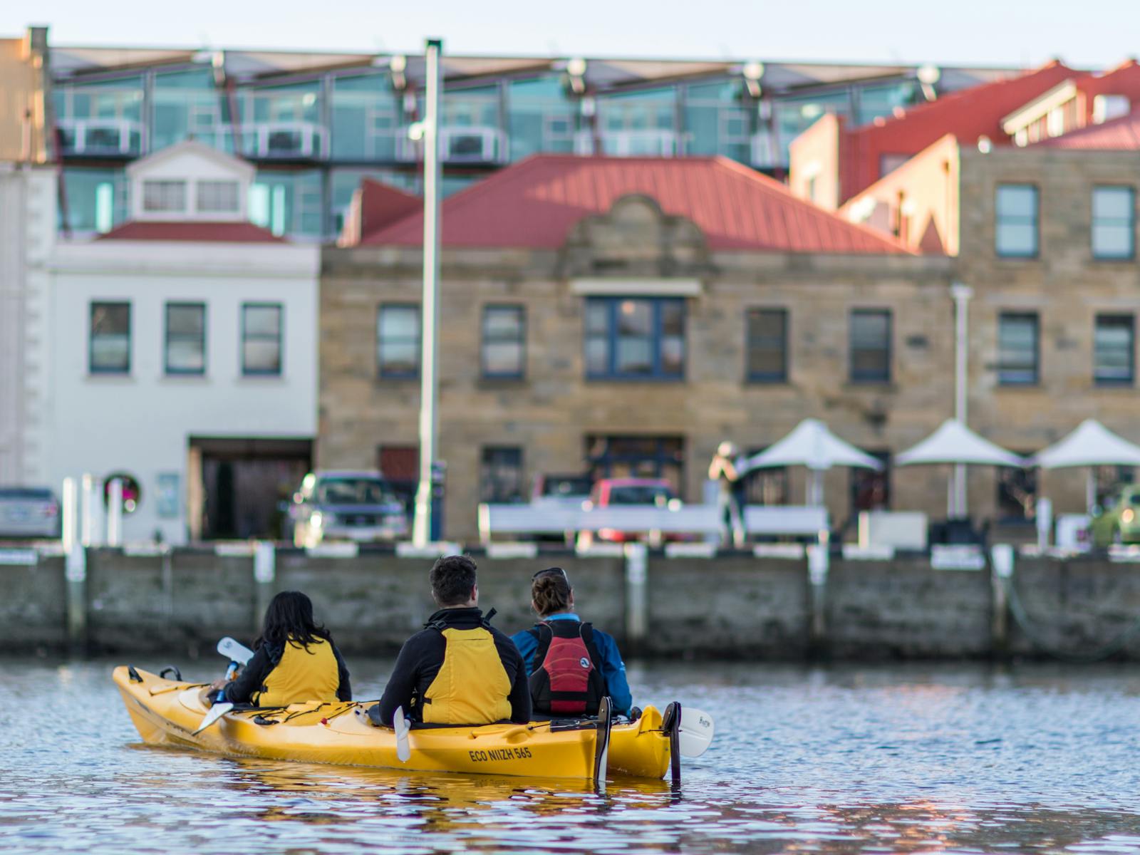 Kayakers relaxing on the water enjoying the view of heritage buildings on the Hobart waterfront
