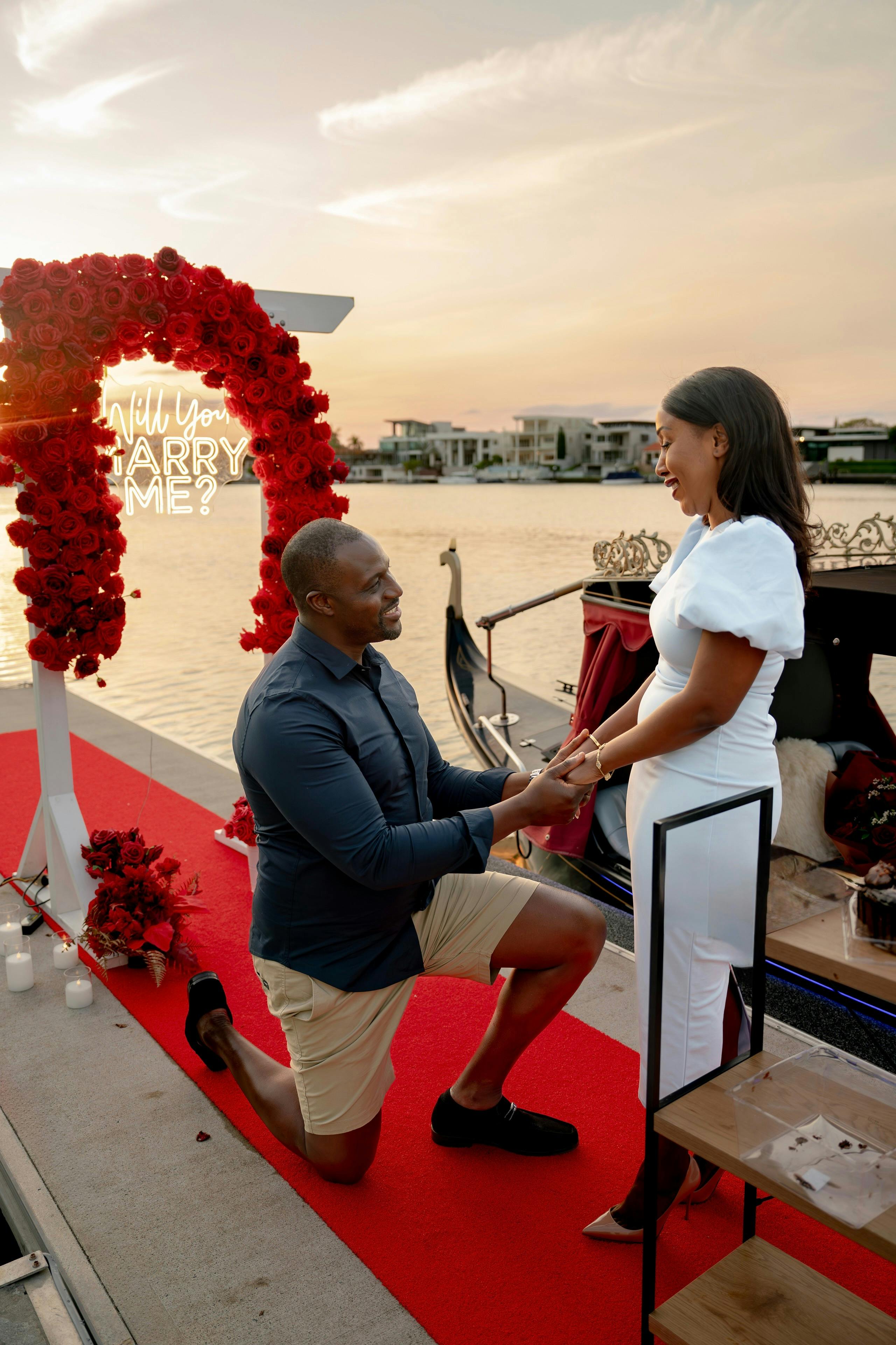We set the stage for your proposal with beautiful touches: Roses, Rose petals, Marry Me sign