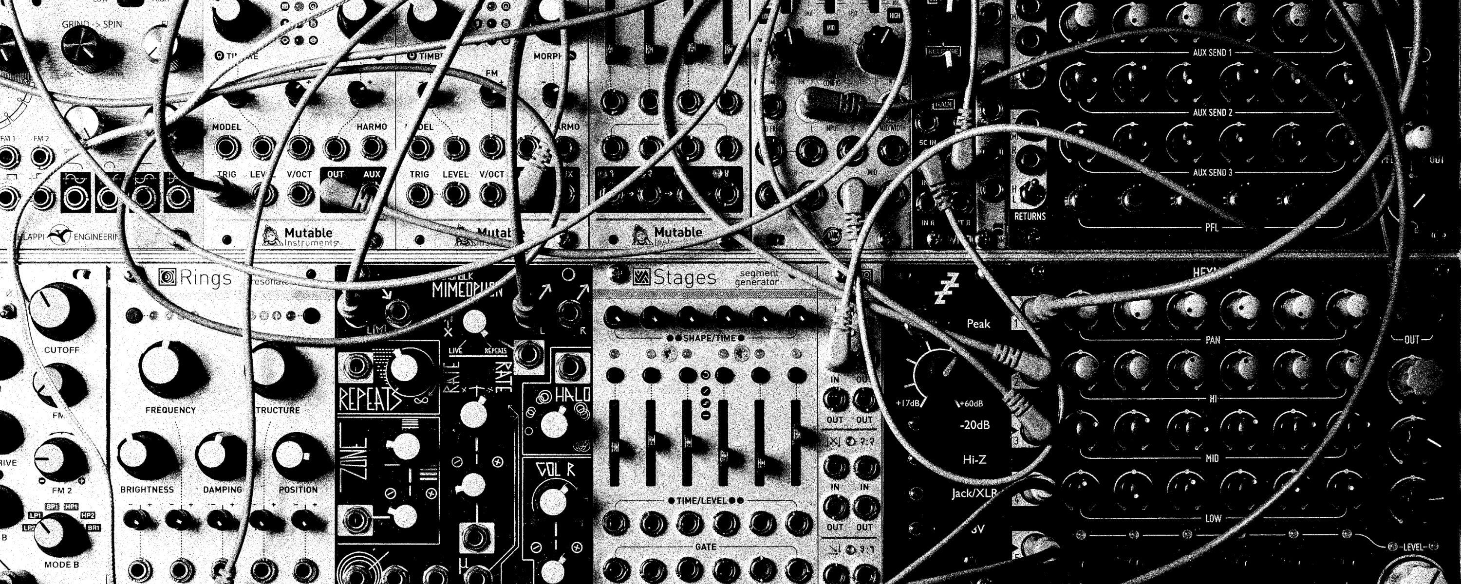 A series of knobs, dials and cords plugged into electric music equiment