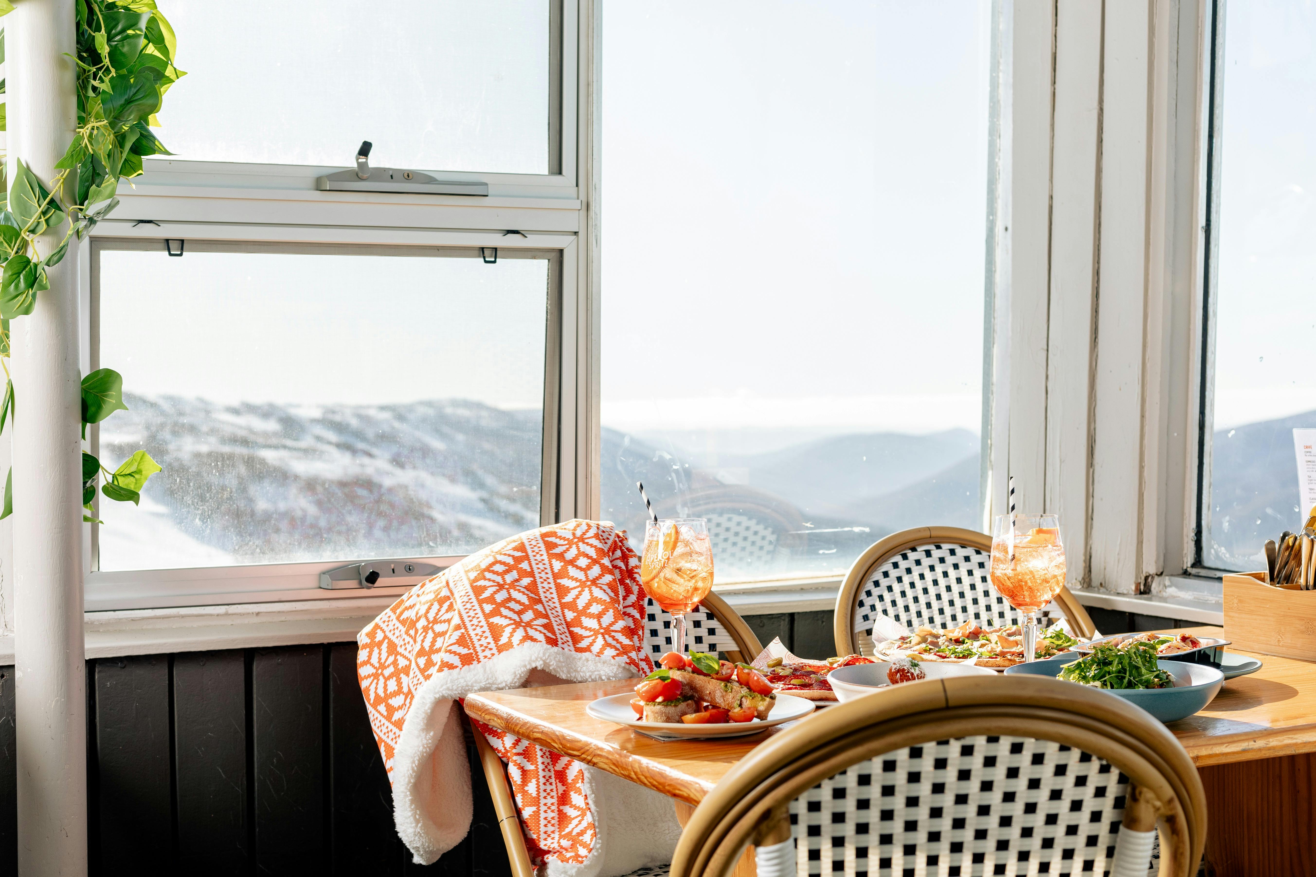 One of the dining tables at Eagles Nest, with a view over Thredbo,the valley & snow capped mountains