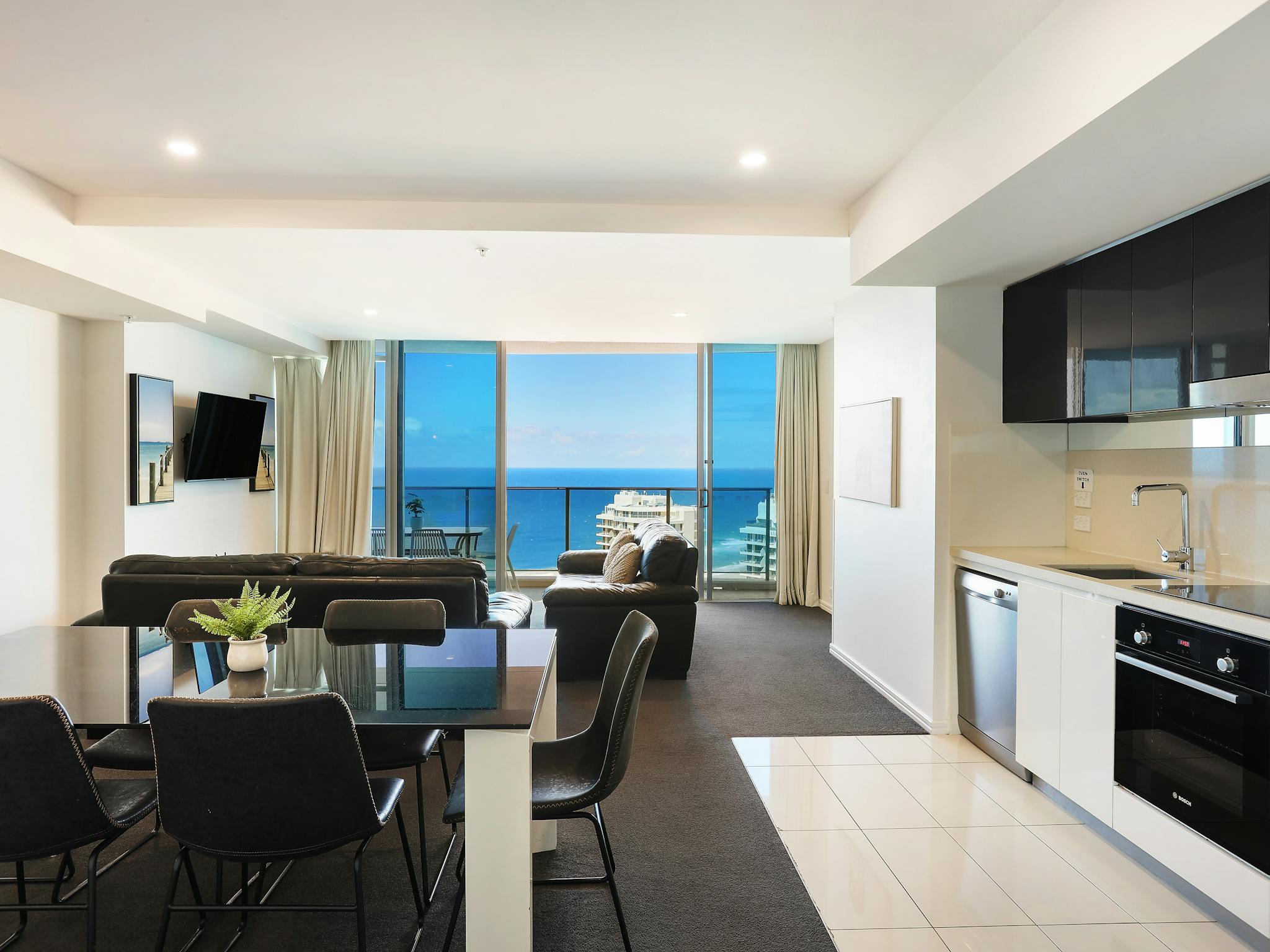 Open plan living - kitchen, dining, lounge room, balcony with ocean views - Hilton Surfers Paradise Open plan living - kitchen, dining, lounge room, balcony with ocean views - Hilton Surfers Paradise