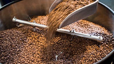 Coffee beans in a large grinder
