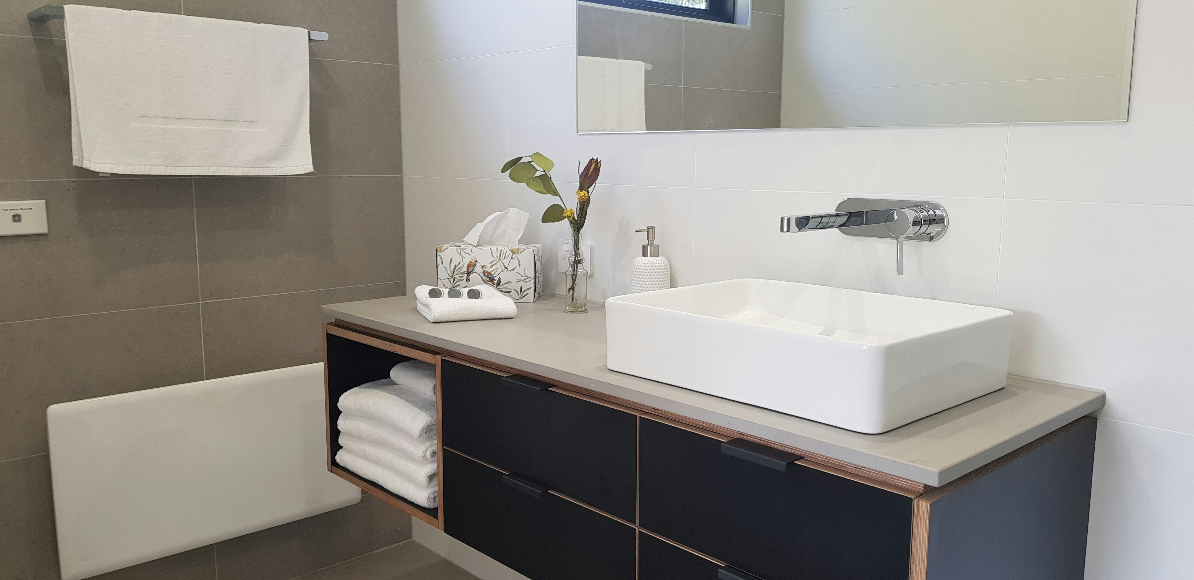 Locally crafted vanity with quality fittings. Plush towels, toiletries provided.