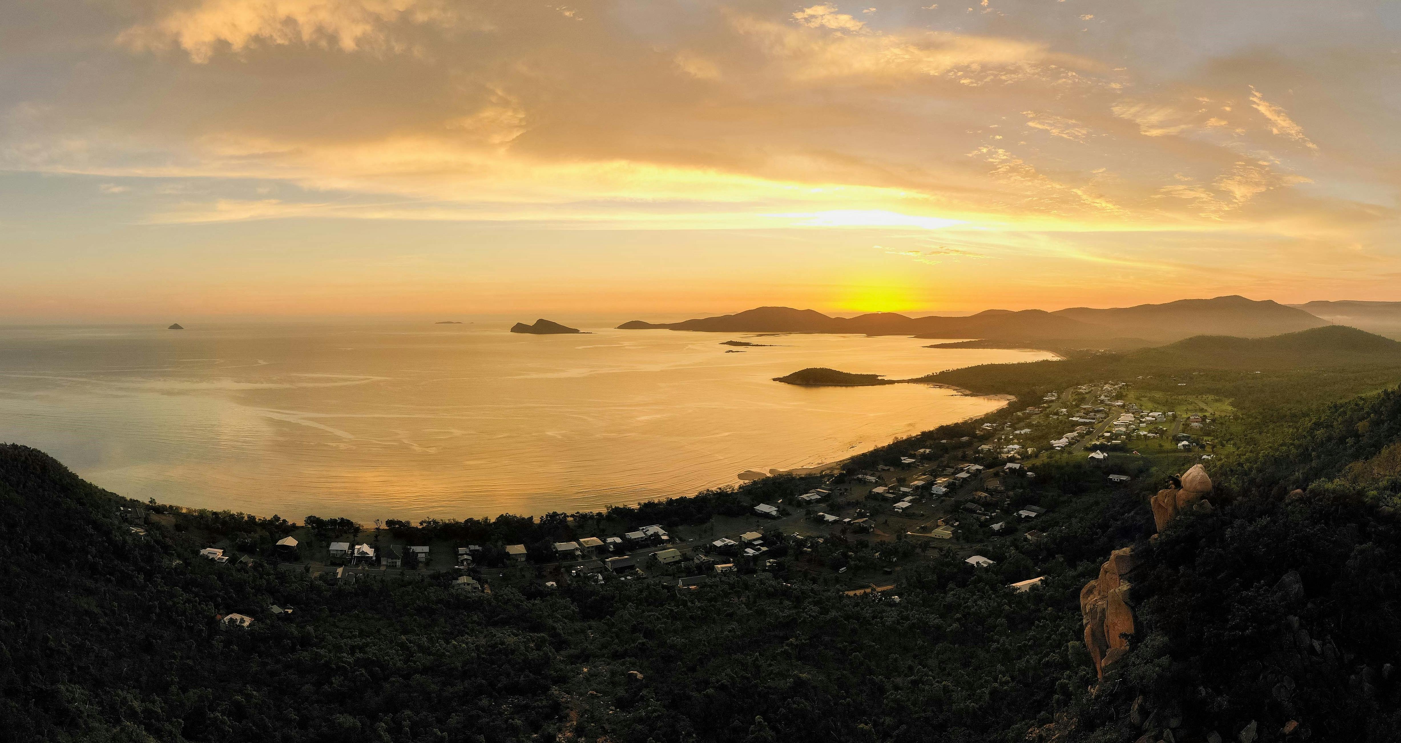 Aerial view from a hilltop at sunset overlooking homes and water at Hydeaway Bay