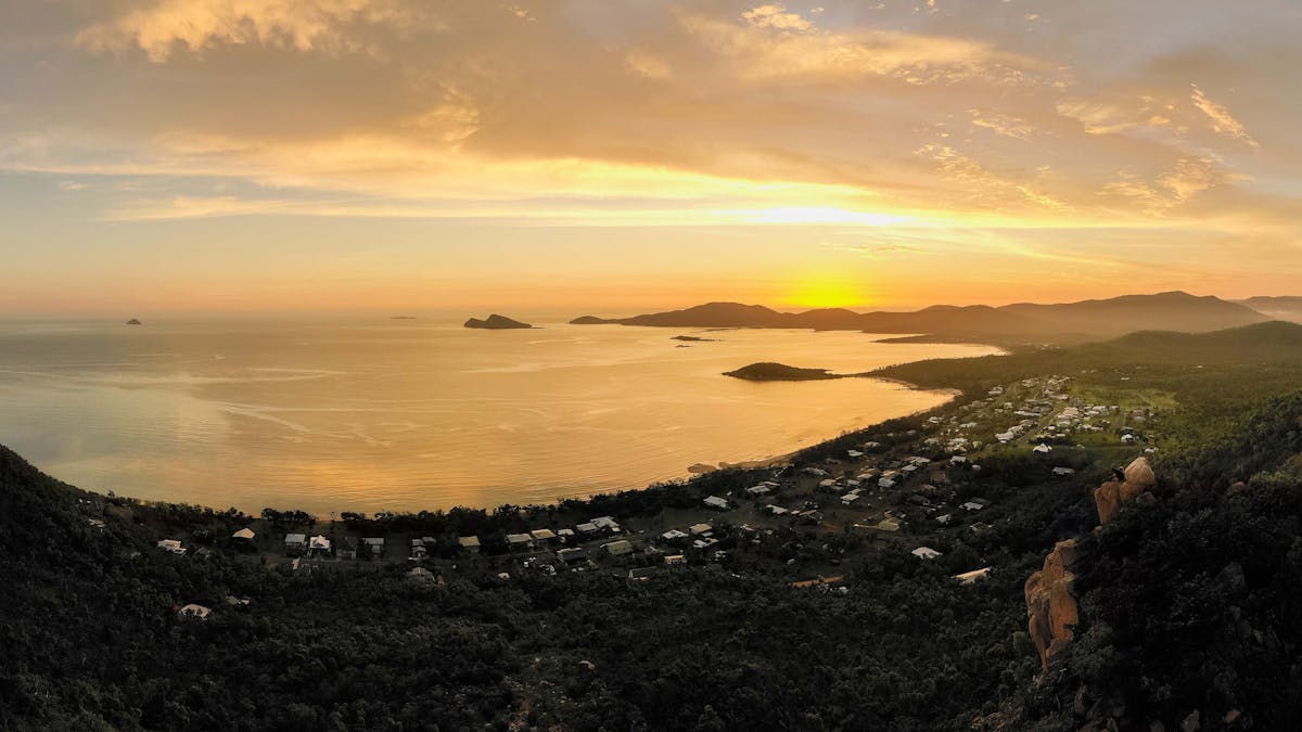 Aerial view from a hilltop at sunset overlooking homes and water at Hydeaway Bay