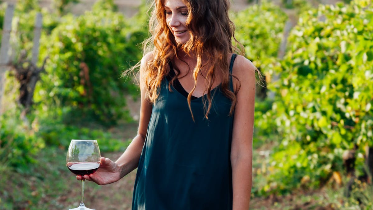 Enjoying a glass of wine strolling in the vineyard