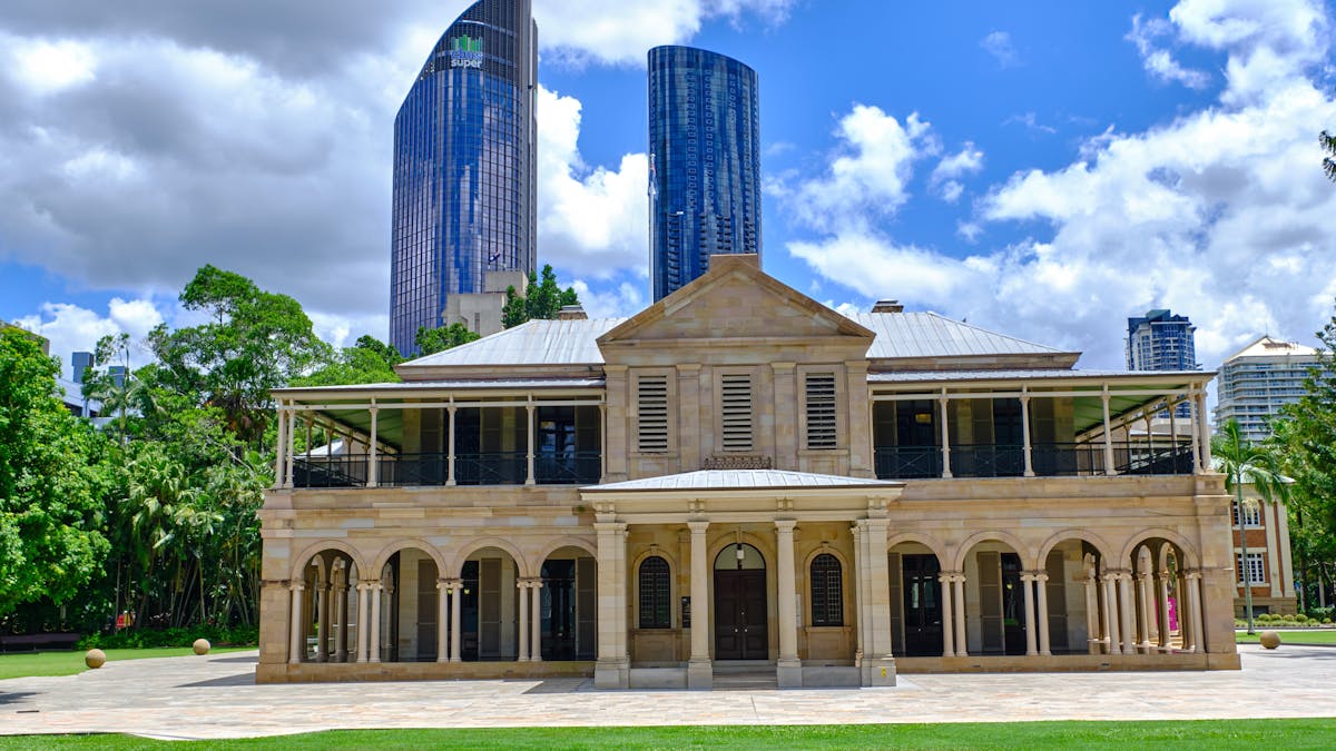 Colonial building with columns in front of skyscrapers