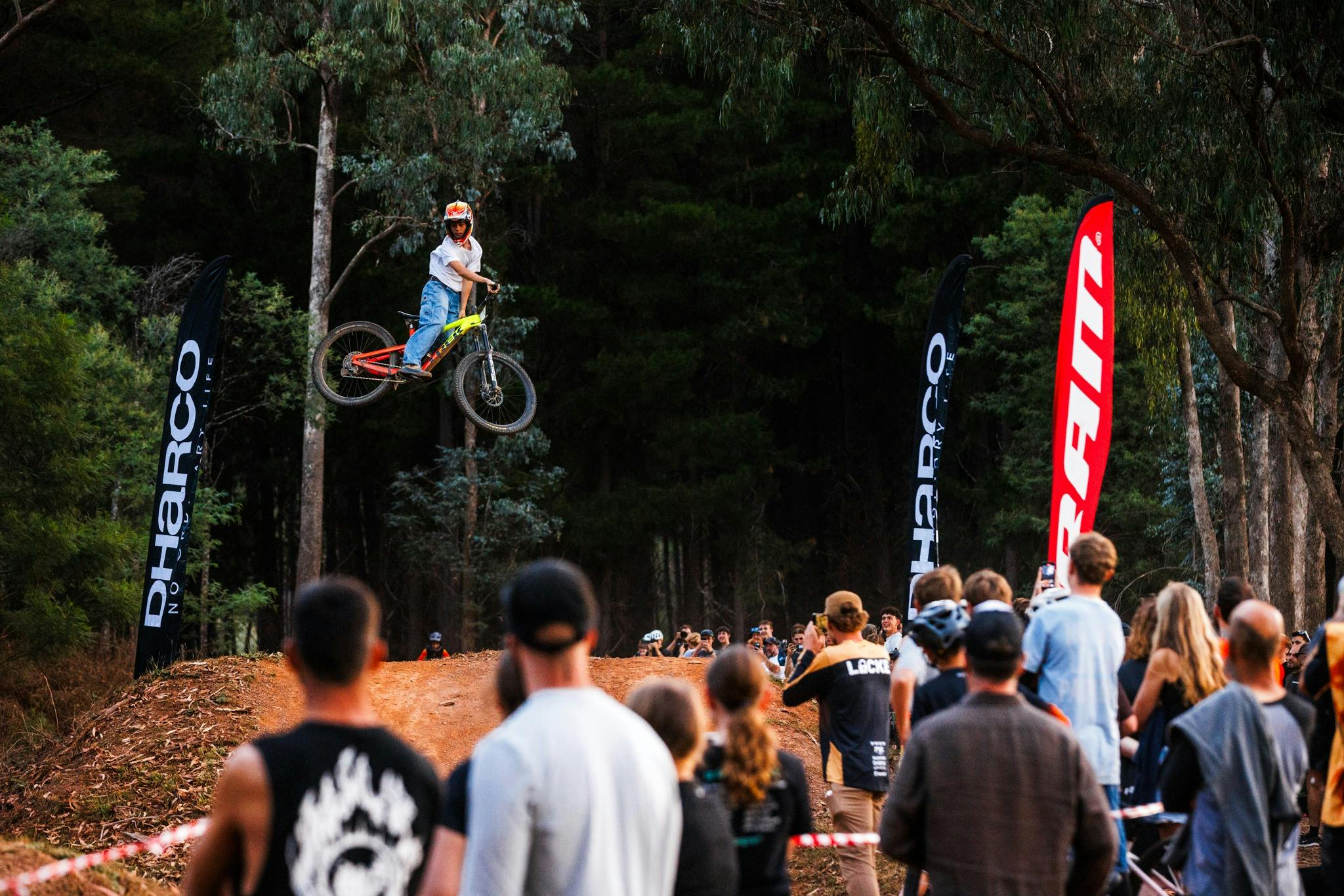 A person jumping a bicycle between dirt jump at Mystic Bike Park