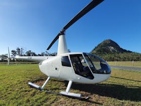 Photo of helicopter in front of mountain