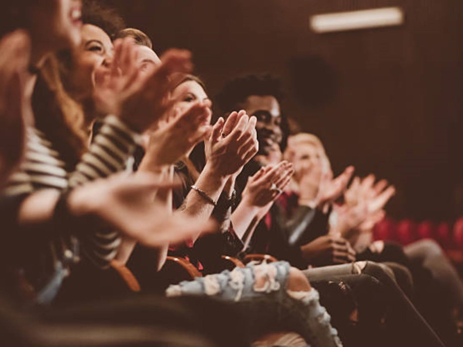 Crowd clapping in theatre