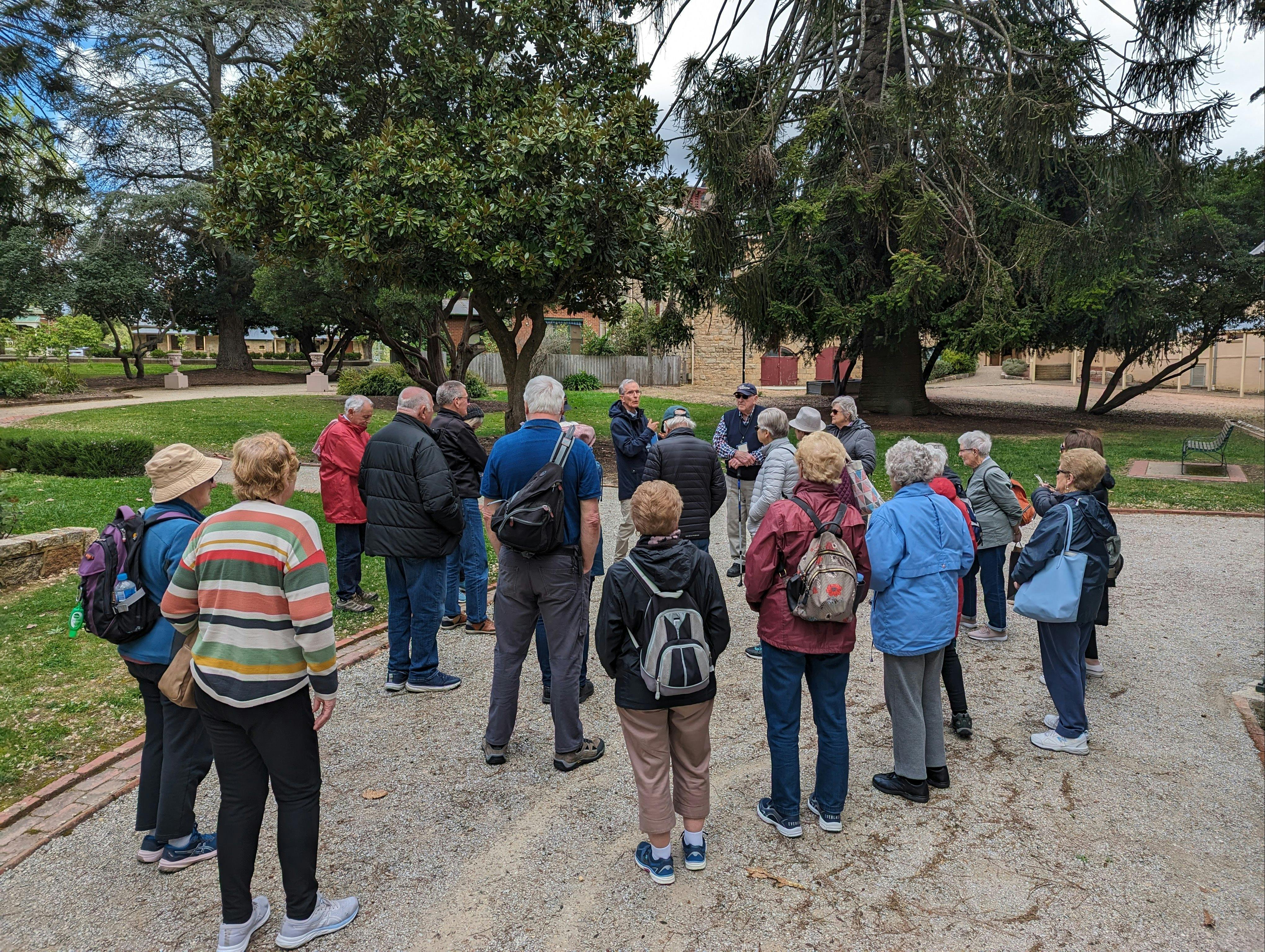 Group of people listening to a tour guide overlooking the botanic garden