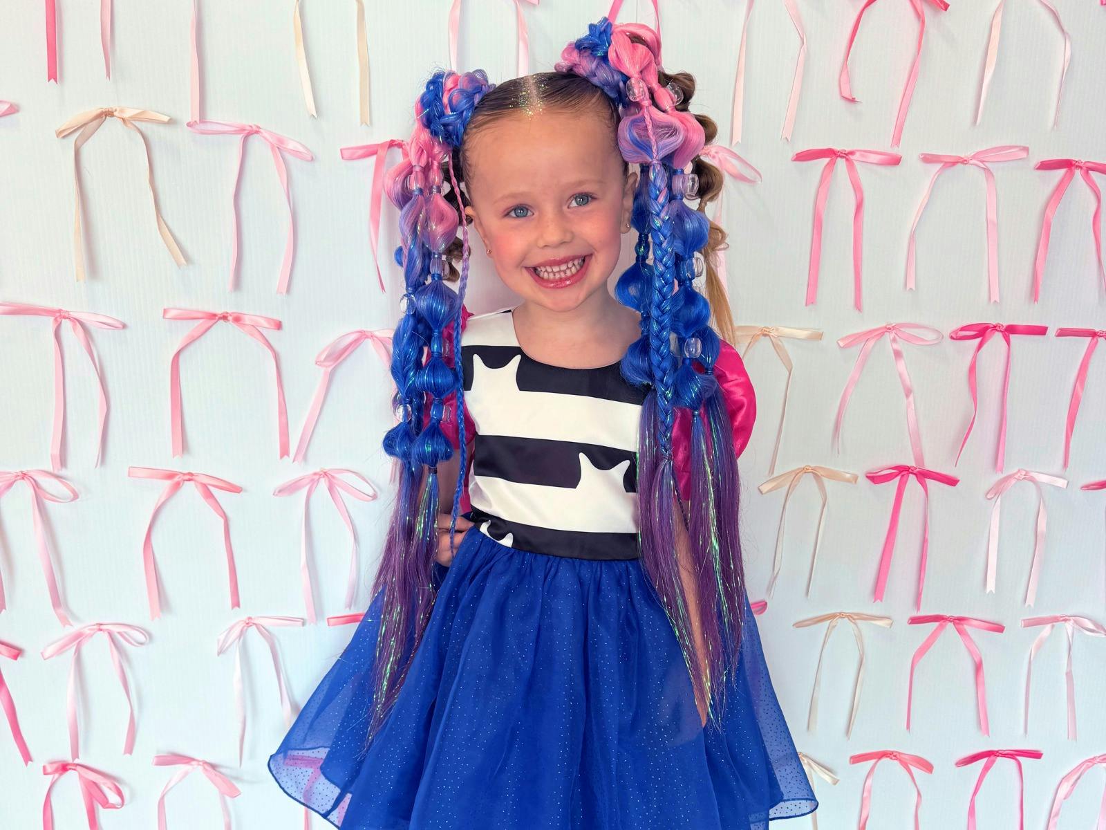 Girl with blue and pink braids in pig tails